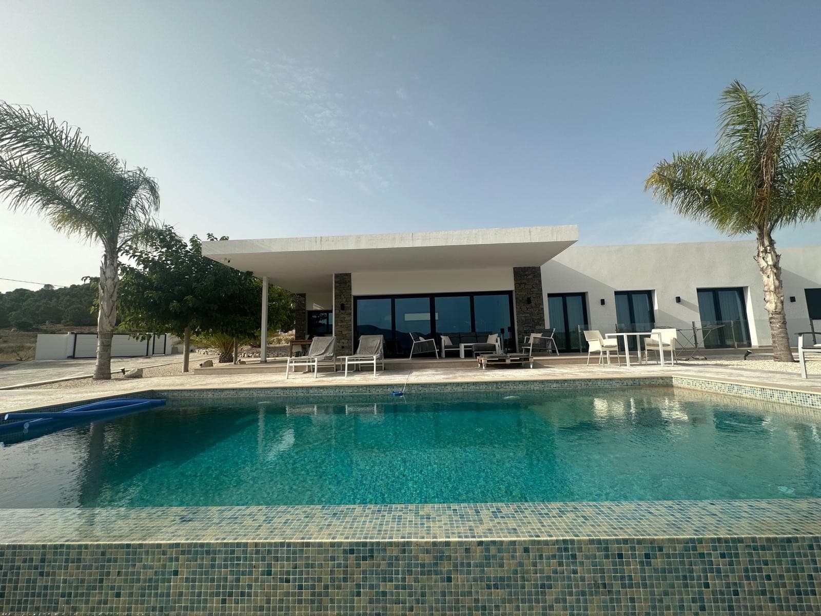 This off-plan villa offers a modern design with a 170 m² build area, featuring three bedrooms, two bathrooms, and a bright open-plan kitchen and living space. The layout is functional and designed for comfortable year-round living. A private infinity swimming pool and a garage is included in the price, and the home can be customised to suit your needs.The villa will be built on a 10,000 m² plot, which is not included in the base price. We offer a wide selection of over 150 legal building plots across various countryside locations. Plot prices and final costs may vary depending on the location and features chosen.This type of new build is ideal for those seeking space, privacy, and flexibility, while still being within easy reach of towns like Pinoso, La Romana, or Monóvar. These areas are known for their scenic surroundings, vineyards, and traditional Spanish charm, yet they remain close to the coast and Alicante airport. Perfect for full-time living or as a holiday retreat.We have a large portfolio of properties in the Costa Blanca and Costa Calida areas, specialising in country properties, villas, fincas, building plots and design and build options in the Alicante and Murcia regions with a particular emphasis on Elda, Monovar, Pinoso, Sax, Villena, Aspe, Fortuna, Albacete and many more surrounding areas. We have been established since 2004 and have decades of experience between the team which we bring to bear to help you find and secure your new dream home. We help you every step of the way to make sure your purchase in Spain is safe and hassle free. We are not here to sell you a property, we are here to help you realise your dream and find what is right for you. With us you are in the safest hands. Contact us now to have a no obligation chat about how you too can realise your dreams.