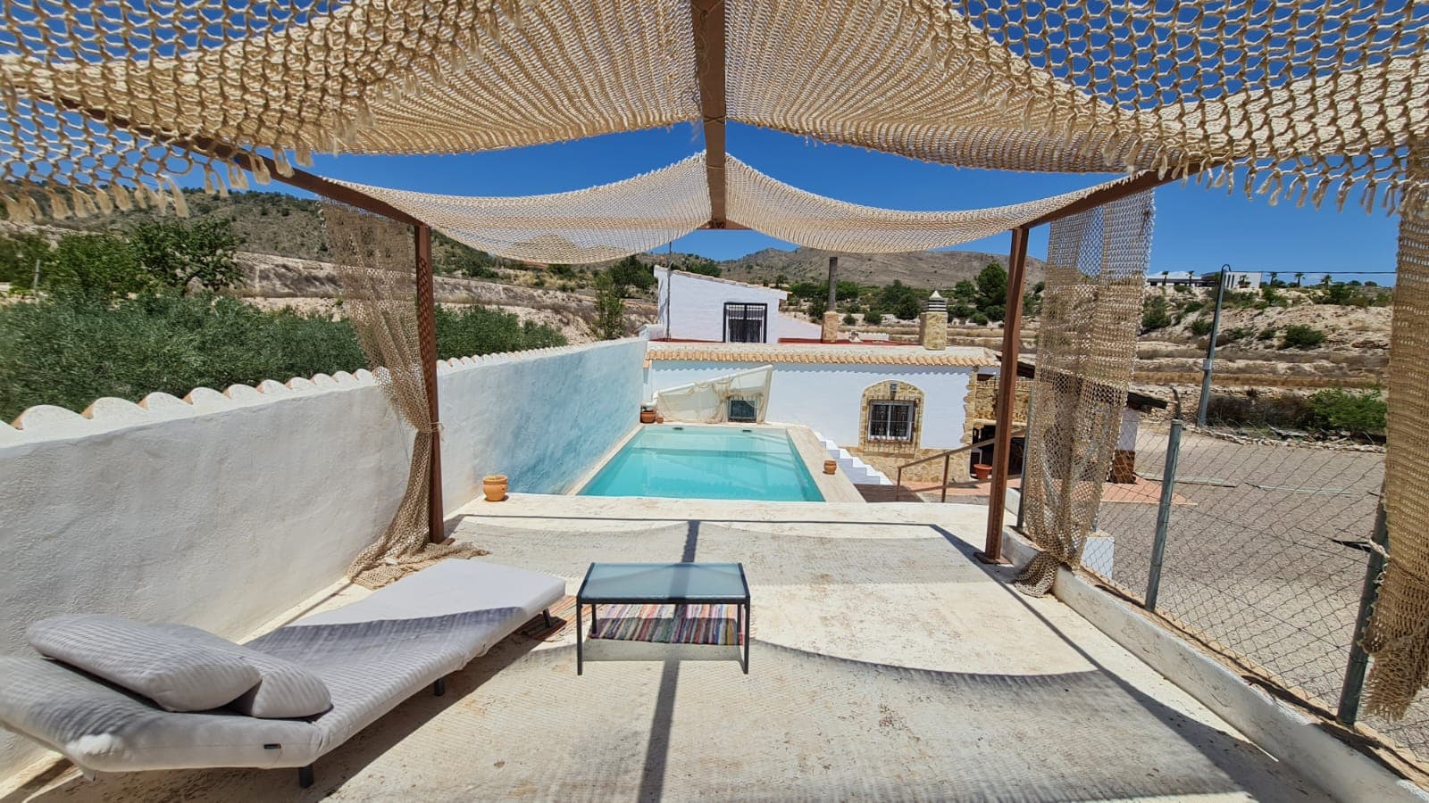 This charming villa in La Romana, Alicante, sits on a 3,100 m² plot surrounded by olive, almond, and fruit trees, offering a peaceful rural setting with great potential. The main house has 90 m² spread over two floors and includes three bedrooms, a living room with a fireplace, a spacious bathroom, and a functional kitchen. There's also an underground wine cellar, ideal for storage or wine enthusiasts. A 30 m² covered porch provides a shaded outdoor seating area.Outside, you'll find a private salt water pool, a barbecue area with a marble countertop and shed, and a poolside storage room. Additionally, a 40 m² outbuilding on the plot offers the opportunity to convert it into a guest house or studio.La Romana is a welcoming inland village located about 40 minutes from Alicante city and its airport. Known for its vineyards, olive groves, and traditional charm, the area offers a relaxed lifestyle while still being close to shops, restaurants, and healthcare services. It's a popular choice for those seeking privacy, space, and a connection to the surrounding countryside.We have a large portfolio of properties in the Costa Blanca and Costa Calida areas, specialising in country properties, villas, fincas, building plots and design and build options in the Alicante and Murcia regions with a particular emphasis on Elda, Monovar, Pinoso, Sax, Villena, Aspe, Fortuna, Albacete and many more surrounding areas. We have been established since 2004 and have decades of experience between the team which we bring to bear to help you find and secure your new dream home. We help you every step of the way to make sure your purchase in Spain is safe and hassle free. We are not here to sell you a property, we are here to help you realise your dream and find what is right for you. With us you are in the safest hands. Contact us now to have a no obligation chat about how you too can realise your dreams.