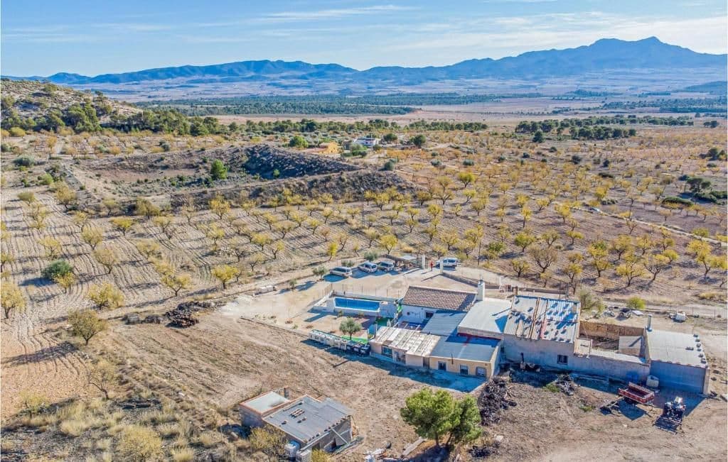 A home with character and plenty of potential, located in one of the most special and peaceful areas of inland Murcia, with fantastic views, only 12 minutes drive from Pinoso. Surrounded by nature in the heart of the Sierra del Carche Natural Park, this unique 230 m² single-storey semi-detached villa offers space, tranquillity, and the charm of rural living in a protected natural setting — ideal for hiking lovers and those seeking peace and privacy. The house is ready to move in, sold furnished, and in a great condition.Set on a 25,000 m² estate with almond trees, the property includes:8 bedrooms,4 bathrooms, 3 living rooms, 2 kitchensa laundry room, storage areas, a wine cellarboth open and enclosed terraces Outside, you'll find a swimming pool with outdoor bathroom and shower, a recreation area, dog kennel, parking space, and automatic gate. The entire property is fenced, providing privacy and security in this beautiful natural environment. Perfect occasion for a large family, hosting guests, or even developing a rural tourism project.About the area: Jumilla is a charming town renowned for its scenic vineyards, stunning natural landscape, and vibrant local culture. Known primarily for its award-winning wines, this picturesque town offers a perfect blend of traditional Spanish character and modern living. With its historic landmarks, bustling market squares, and beautiful countryside, Jumilla provides an ideal setting for those seeking a peaceful yet vibrant lifestyle in province Murcia, less than 1 hour from Mediterranean sea and 2 major airport - Murcia & Alicante.About us: We have a large portfolio of properties in the Costa Blanca and Costa Calida areas, specialising in country properties, villas, fincas, building plots and design and build options in the Alicante and Murcia regions with a particular emphasis on Yecla, Novelda, Elda, Monovar, Pinoso, Sax, Villena, Aspe, Fortuna, Jumilla, Abanilla, and many more surrounding areas. We have been established since 2004 and have decades of experience between the team which we bring to bear to help you find and secure your new dream home. We help you every step of the way to make sure your purchase in Spain is safe and hassle free. We are not here to sell you a property, we are here to help you realise your dream and find what is right for you. With us you are in the safest hands. Contact us now to have a no obligation chat about how you too can realise your dreams.