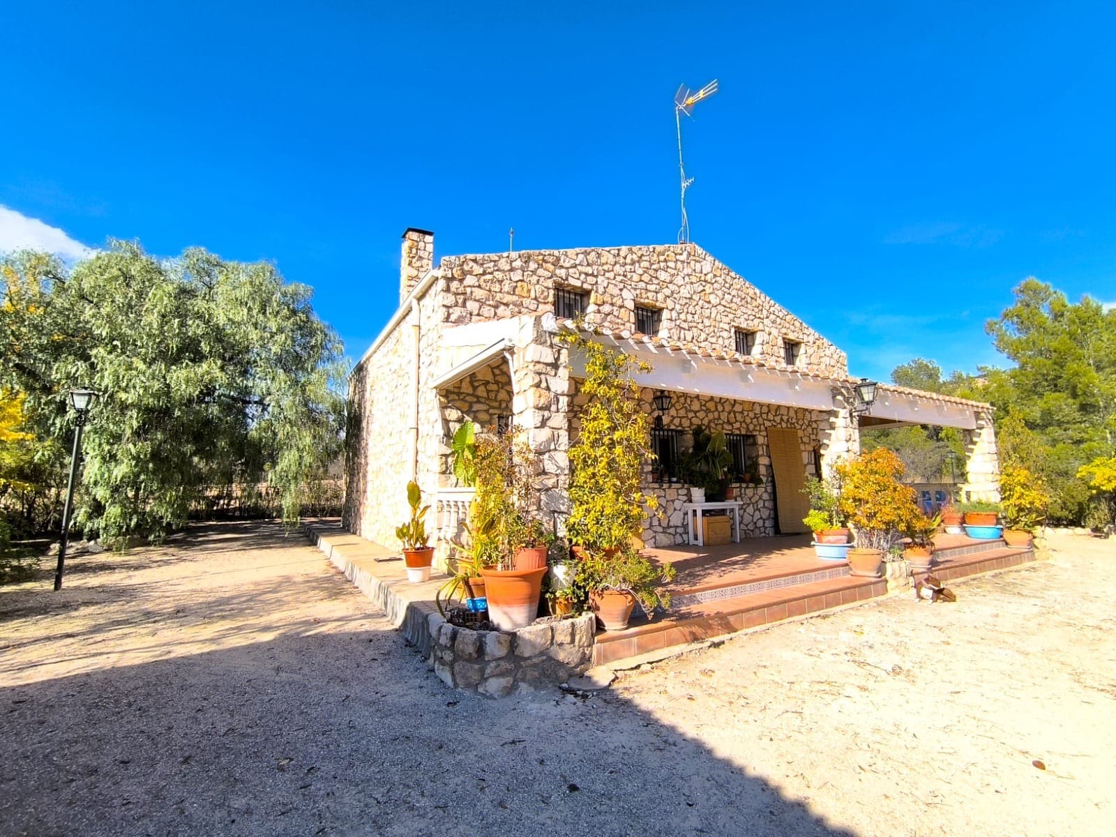 Magnificent country property with a double house, a guest house, own well, and stunning views: This property includes a large villa made from natural stone, consisting of two adjoining two-storey apartments, mirroring each other, each with a large living room with a fireplace and an open kitchen, a bathroom, and 3 bedrooms upstairs. Extra feature is an independent guest house with a large dining room.One of the standout features of this estate is its unique construction, as the houses are clad with local natural stone. This traditional craftsmanship not only gives the property a distinctive character but also ensures extraordinary durability, built to last a lifetime.Outside, the estate features a swimming pool with filtration system, a double garage, and a barbecue area. The property is equipped with solar panels for electricity plus a gasoline backup generator. It also benefits from its own natural spring water well, providing excellent autonomy.The land comprises 8,500 m², planted with fruit trees and olive trees in production. Surrounded by mountains and nature, the property enjoys beautiful panoramic views and exceptional peace and privacy. Protected area of Monte Arabí is in a hiking distance.A unique opportunity for those seeking nature, independence, traditional craftsmanship, and an estate with multiple possibilities. It is ideal for a multi-generational family residence, holiday home, or a rural project.About the area: Yecla is a charming and historic town of app. 35000 inhabitants, located in the region of Murcia. It is renowned for its award-winning wines, historical landmarks, and vibrant local culture. The surrounding natural landscapes of scenic mountains, vineyards and almond groves provide opportunities for outdoor activities, while the town itself offers all necessary services, including hospital, schools, shops, restaurants, and other services. With a friendly local community, lively markets, excellent gastronomy, and easy access to nature, Yecla is an ideal location for those seeking authentic Spanish lifestyle - just about an hour from the coast and Alicante airport.About us: We have a large portfolio of properties in the Costa Blanca and Costa Calida areas, specialising in country properties, villas, fincas, building plots and design and build options in the Alicante and Murcia regions with a particular emphasis on Yecla, Novelda, Elda, Monovar, Pinoso, Sax, Villena, Aspe, Fortuna, Jumilla, Abanilla, and many more surrounding areas. We have been established since 2004 and have decades of experience between the team which we bring to bear to help you find and secure your new dream home. We help you every step of the way to make sure your purchase in Spain is safe and hassle free. We are not here to sell you a property, we are here to help you realise your dream and find what is right for you. With us you are in the safest hands. Contact us now to have a no obligation chat about how you too can realise your dreams.