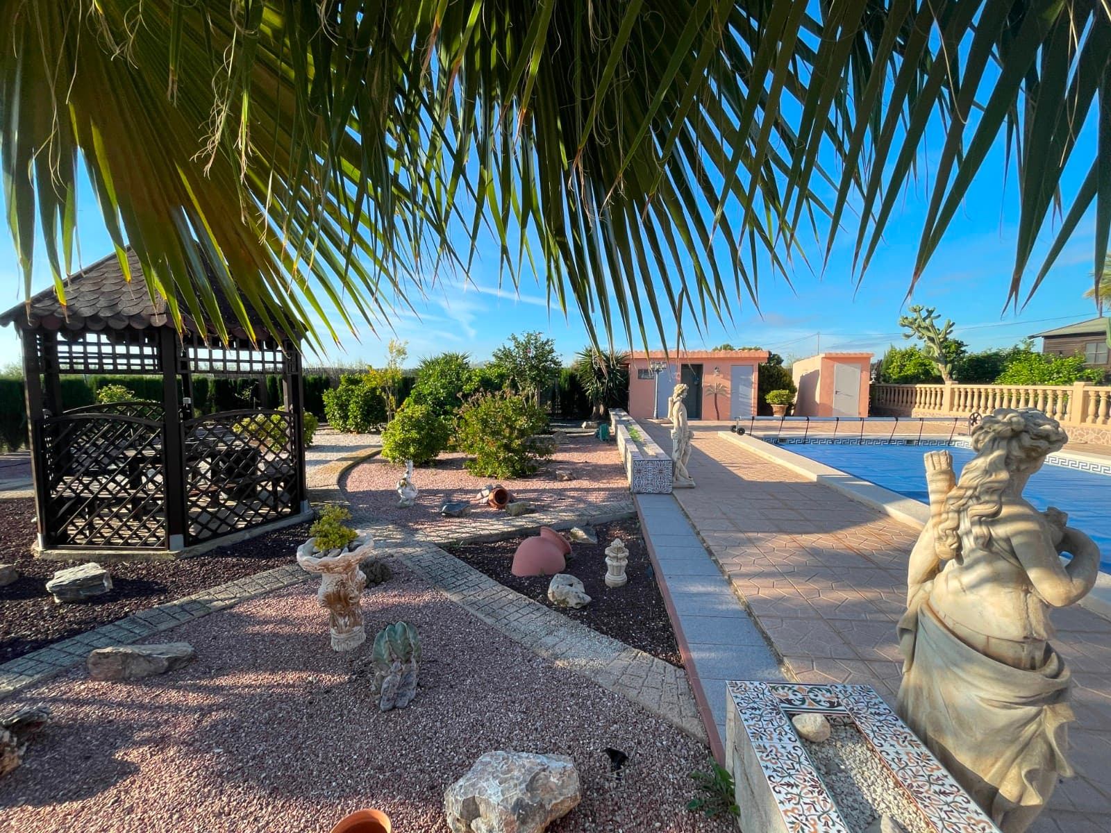 Rustic House in Crevillente – Fully Legalized and Ready to DeedIntroducing this beautiful rustic property in Crevillente, with all documentation in perfect order, making it a unique and worry-free opportunity. The property includes a certificate of occupancy, energy certificate, positive inspection report, and updated septic tank. Everything is ready for immediate transfer of ownership.General Features Plot size: 4,412 m² Total built area: 315 m² Main House (184 m²) A bright, well-maintained home featuring: Spacious living-dining room with access to porch and enclosed terrace Large kitchen with pantry/storage area 3 double bedrooms 2 full bathrooms Warm, comfortable spaces ideal for year-round living Additional Buildings and Spaces The property includes several auxiliary constructions offering great versatility and multiple uses: Wooden cabin with covered terrace, perfect as an entertainment area or guest house Second wooden cabin, currently used as a tool shed but suitable for conversion into accommodation Brick-built structure, ideal as a workshop, garage, or additional guest unit Summer kitchen with barbecue and a closed storage area that could easily become another guest house By the swimming pool, there are outdoor bathrooms and showers, perfect for summer days.Surroundings and Services Land with fruit trees and olive trees, separated from the main area by a line of cypress trees Connected to the mains water and electricity networks, plus access to irrigation water Updated electrical installation Conclusion A true paradise, ideal for those seeking peace, comfort, and complete legal assurance. With its excellent condition and comprehensive documentation, this property represents the perfect opportunity to move in or invest with total confidence.