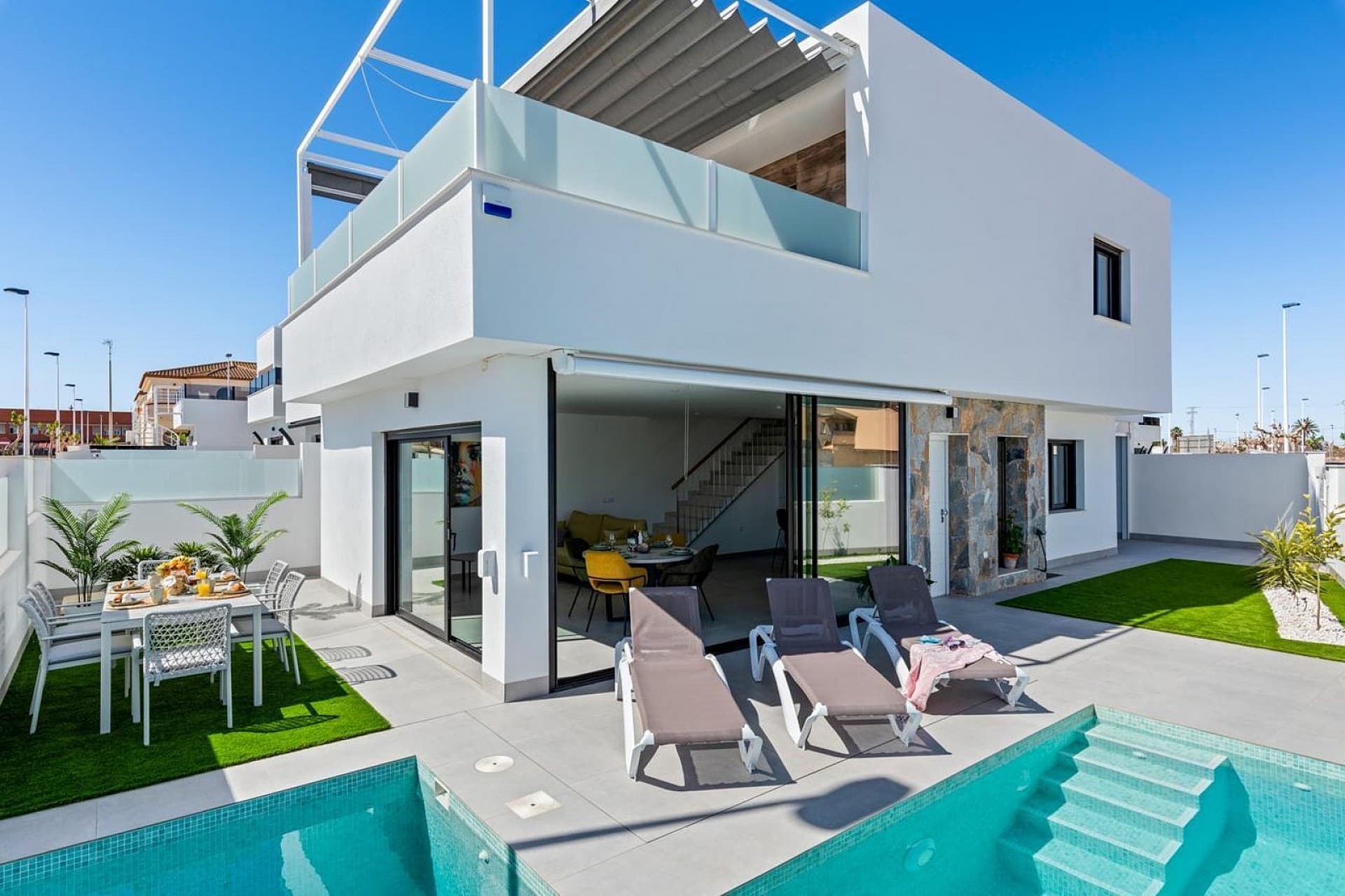 . Stylish Detached Villa with Private Pool, Located on a Corner Plot in Popular San Pedro del Pinatar (Región de Murcia, Spain)This unique property combines peace, comfort, and a central location—ideal as a (second) home or investment for holiday rentals.Layout and ComfortThe villa features 3 comfortable bedrooms and 2 modern bathrooms, suitable for up to 6 people. The open living area is bright and airy, with direct access to the garden. Thanks to the smart layout, you can enjoy both indoor and outdoor living all year round.The home is fully furnished with high-quality materials and is sold including the complete inventory, such as garden furniture, lounge set, sunbeds, air conditioning, smart TV, washing machine, and a fully equipped kitchen with a dishwasher, freezer, and extractor fan.Outdoor Living at Its BestThe spacious plot offers full privacy and includes a beautifully landscaped garden, a private pool, and an outdoor shower. You’ll always find a sunny or shady spot, whether on the large balcony or in the garden. The property also offers a gated garden, a garage, and street parking.LocationThe villa is situated in the Los Antolinos area, within walking distance of the town center, shops, restaurants, and the local Monday market. The beaches of Lo Pagán and the promenade are just a 10-minute bike ride or drive away. There are several golf courses nearby, including Roda Golf and Las Colinas.This location also offers easy access to nature parks, mud baths, and historic cities like Murcia and Cartagena. Murcia-San Javier Airport is nearby, and Alicante Airport is about a 1-hour drive away.Highlights of This Property:Detached villa offering privacy and a luxurious feelPrivate pool and various outdoor spacesFully furnished and move-in readyCentrally located near the beach, town center, and golf coursesPerfect for families, winter stays, or investment purposesThe property is equipped with 12 solar panels.