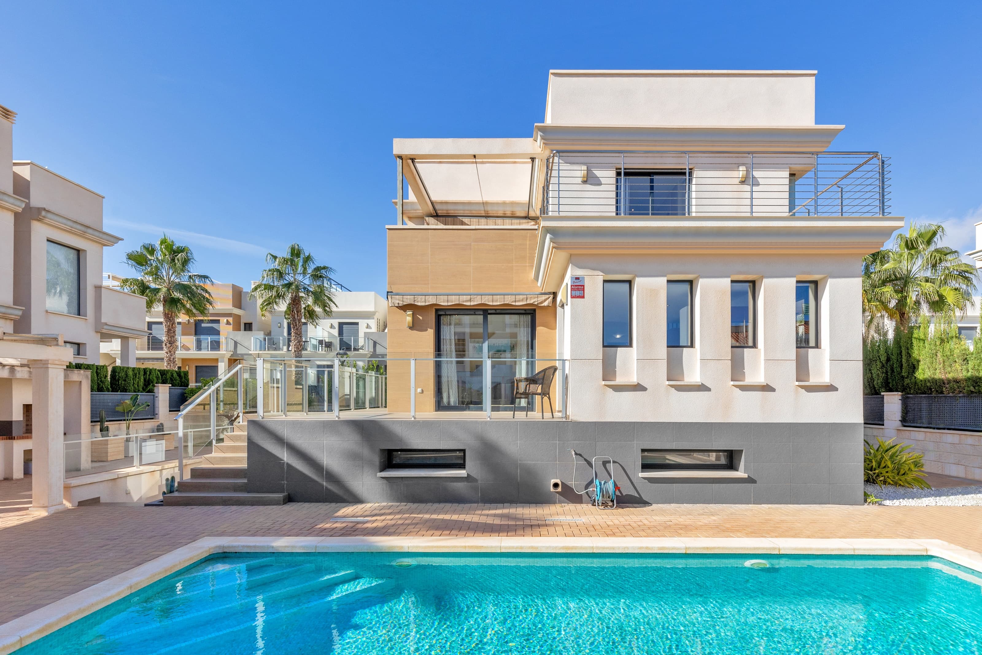 Luxury villa in La Zenia, Orihuela Costa.This villa is situated in an exclusive residential area and has its own private pool and a plot of 410m2. The property has 250m2 built area divided into 4 floors. On the ground floor there is a spacious living room with open plan kitchen, 1 bedroom, 1 bathroom and terrace with access to the pool. On the semi-basement floor there is a living room with open plan kitchen, 2 bedrooms and 1 bathroom. This floor also has a sauna and shower. On the first floor there are 2 bedrooms, each with en-suite bathroom and a large terrace. On the top floor there is a large solarium of 46m2.La Zenia is close to Cabo Roig, Campoamor and Playa Flamenca. It is a tourist area located close to all amenities of the famous La Zenia Boulevard shopping centre. A few minutes from the N-332 and the Mediterranean motorway AP-7 towards Alicante and Cartagena. There are also around the golf courses of Villamartin, Las Ramblas, Campoamor and Las Colinas.