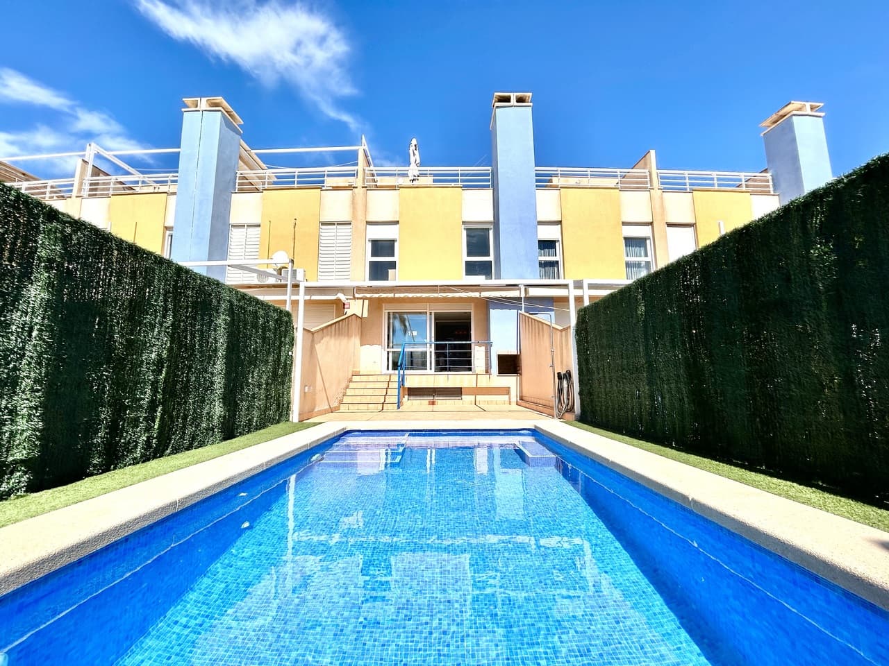 Rare opportunity to purchase this spectacular property in Calas de Campoamor with open sea views, just 100m from the beach. This 3 bedroom, 3 bathroom villa boasts a heated saline swimming pool installed less than 2 years ago along with a private solarium and underground garage and storage room. Located in a gated complex this property has been maintained to a very high standard with a sleek brand new kitchen and very attractive marble flooring throughout. On the ground floor there is fantastic living and dining room with floor to ceiling patio doors leading outside the the tiled terrace and swimming pool which has been finished with artificial grass. On the first floor you with find the master bedroom that enjoys sea views and en-suite bathroom along with two double guest bedrooms and the family bathroom all with views towards the sea or the communal swimming pool. On the top floor you will find the fabulous solarium with more stunning views of the Mediterranean and down towards the Mar Menor. The villa has an underground garage and storage accessed via an internal staircase, where you can conveniently access your car and exit the complex via electric doors. The house forms part of a well maintained complex where home owners also have use of the huge communal swimming pool and pretty garden. The property is sold as seen, fully furnished with many, many extras including independent laundry room, new air-conditioning units in the bedrooms, brand new kitchen appliances, non-chemical saline heated pool system, automated garage doors, intercom entry system, open fireplace in the living room and purpose built barbecue on the main terrace.Calas de Campoamor is a sought after location with all amenities within a few minutes walking distance including an international supermarket and bakery, 24hr pharmacy and medical centre along with a vast array of restaurants, cocktail and tapas bars.