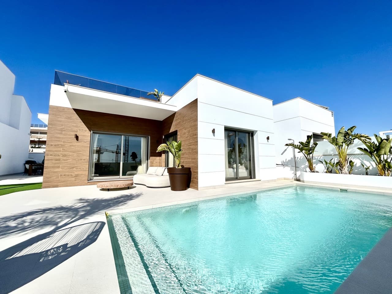 Set within a peaceful and exclusive residential area of San Miguel de Salinas, this exceptional three-year-old detached villa offers a refined blend of modern architecture, versatile living space, and energy-efficient design — perfect for those seeking comfort, privacy, and Mediterranean luxury.The main living accommodation is arranged across one beautifully designed level, featuring three spacious bedrooms and two stylish bathrooms. The open-plan living and dining area is filled with natural light and flows seamlessly to the outdoor terrace and private swimming pool, creating an ideal setting for both relaxed family living and sophisticated entertaining.A standout feature of this property is the private rooftop solarium, offering panoramic views and an additional outdoor living space. Complete with a fully equipped outdoor kitchen, it provides the perfect environment for al fresco dining, sunset drinks, and year-round entertaining under the Spanish sky.The villa also benefits from a substantial full-size underbuild, offering exceptional flexibility and lifestyle potential. This level currently comprises:a fourth bedroom and third bathroom, ideal for guests or independent accommodationa large private gym and a separate playroom This expansive space can easily be adapted into a cinema room, home office, guest apartment, or bespoke leisure suite depending on your needs.In addition, the property is fitted with 10 solar panels, enhancing energy efficiency and significantly reducing electricity costs while supporting sustainable living.Key luxury features include:4 bedrooms | 3 bathroomsSingle-level main living for ease and comfortSpectacular rooftop solarium with outdoor kitchenPrivate swimming pool and multiple outdoor entertaining areasLarge, highly versatile underbuild with independent potentialSolar-powered electricity systemQuiet, upscale location close to golf courses, beaches, and amenitiesThis villa presents a rare opportunity to acquire a nearly new, energy-efficient home with extensive indoor and outdoor living space in one of the most desirable areas of the southern Costa Blanca — ideal as a permanent residence, executive holiday retreat, or premium investment property.