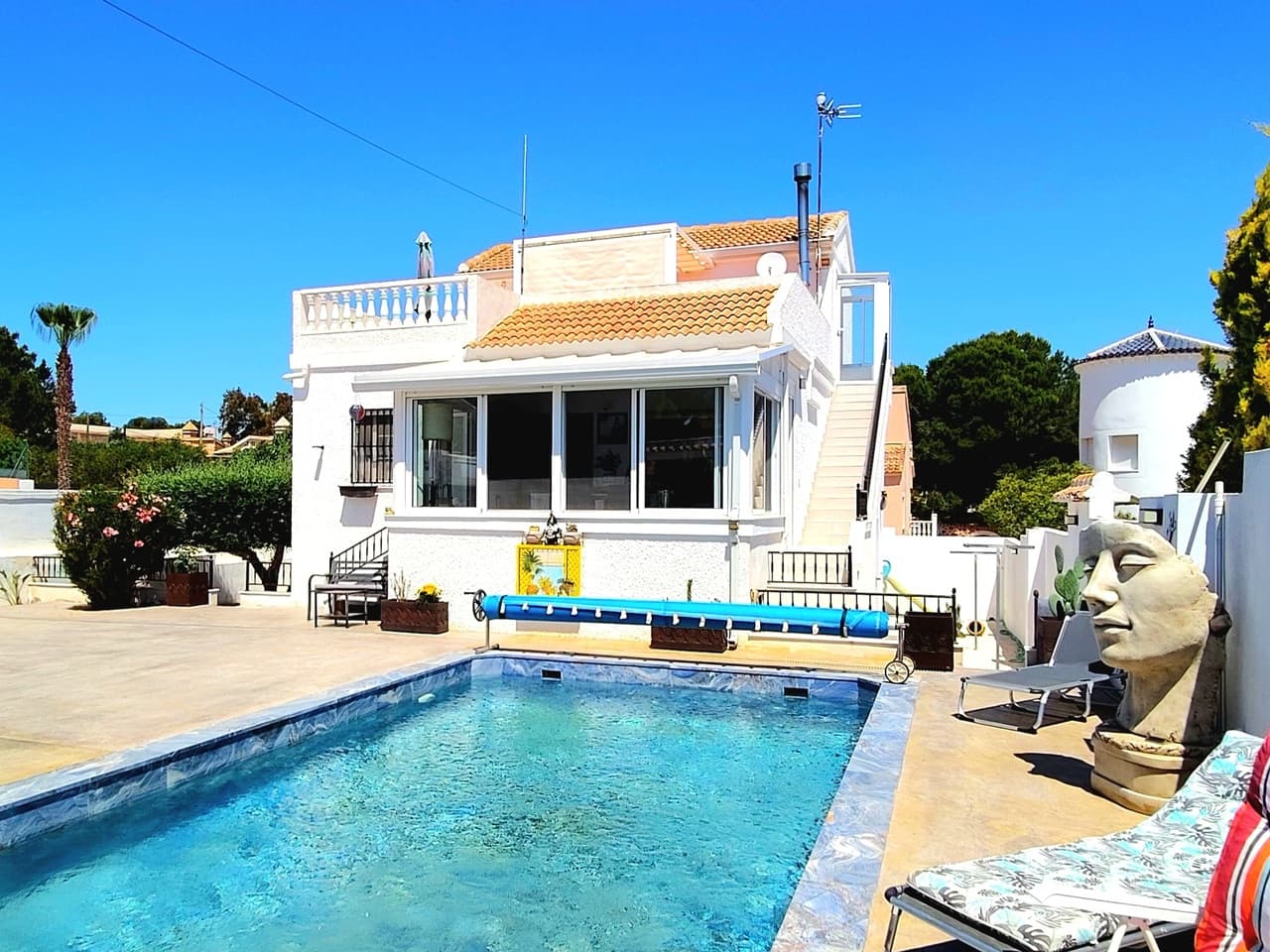 Find your perfect Mediterranean retreat with this exceptional 3-bedroom, 2-bathroom villa for sale in Vistabella. This detached property is fully equipped for modern living, powered by 15 high-efficiency solar panels and 3 storage batteries for eco-friendly peace of mind. The expansive outdoor grounds are a sun-drenched paradise, featuring a pristine, fully renovated private swimming pool, a secure closed garage with space for 2 cars, and an outdoor kitchen for unforgettable summer barbecues under the stars. Whether you are lounging by the poolside or entertaining guests, the incredible exterior space provides the perfect setting to embrace the relaxed Costa Blanca lifestyle.Step inside to explore a bright and beautifully modernised open-plan living space that effortlessly combines a contemporary kitchen, dining area, and a cosy lounge equipped with air conditioning and a feature wood burner for year-round comfort. The sleek, dark-toned kitchen is a chef's delight, complete with an elegant central island and integrated appliances, making it the perfect social hub for entertaining. Conveniently located on this main floor are two generously sized bedrooms. Upstairs, you will find the third bedroom, a second fully equipped kitchen, and a second bathroom, offering unparalleled privacy for visitors. This level leads out onto a spacious terrace where you can enjoy your morning coffee against a stunning backdrop of mountain views.The true hidden gem of this home lies below: a fully renovated basement featuring a rustic brick-and-stone wine cellar (bodega) with authentic arched bottle racks that promise to be the talking point of every dinner party.Golf enthusiasts will delight in the close proximity to Vistabella Golf, while the stunning, sandy beaches of the coast are just a short drive away. Conveniently connected to regional international airports for stress-free travel, this remarkable home is a rare find on the market.