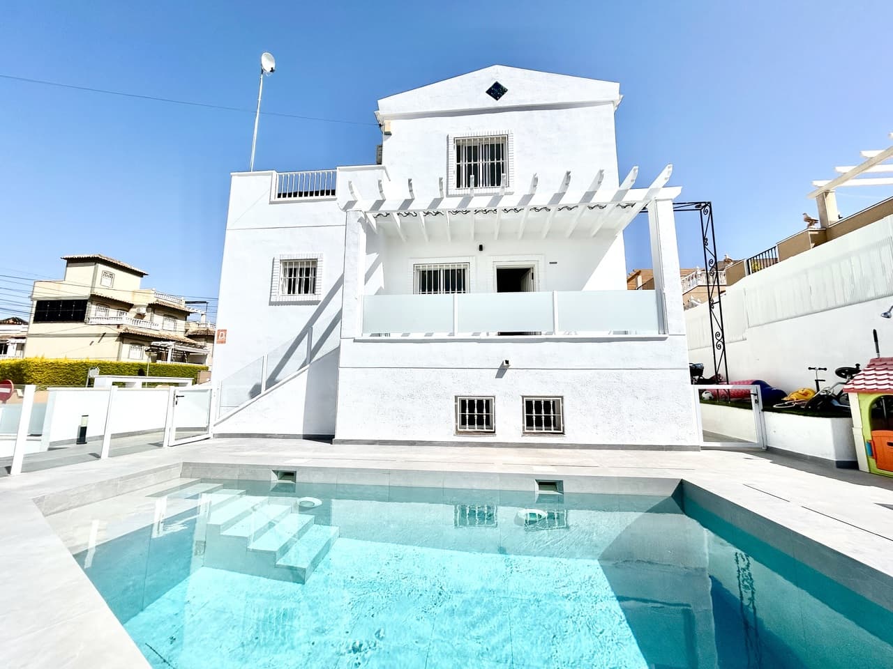 Step into luxury living with this exceptional fully renovated 5-bedroom, 4-bathroom villa in the highly sought-after area of Villamartín.Designed with both style and versatility in mind, this bright and modern property is cleverly distributed across two independent living spaces—ideal for large families, hosting guests, or generating rental income.The main upper level offers a sleek and contemporary living environment, featuring a fully fitted modern kitchen, a spacious and light-filled lounge, and three beautifully designed bedrooms with two stylish bathrooms. From this level, you also have access to a private solarium—perfect for relaxing and enjoying the Mediterranean sunshine. Completing this floor is its own private swimming pool, creating an exclusive and tranquil outdoor space.Downstairs, the villa continues to impress with a fully self-contained living area, complete with its own private entrance. This level includes two generous bedrooms, two modern bathrooms, a fully equipped kitchen, and a comfortable living room—ideal for extended family, guests, or as a separate rental unit. It also benefits from access to a second private pool, giving both levels their own independent outdoor areas.Finished to a high standard throughout, the villa combines modern design with bright, open spaces and quality finishes, creating a stylish yet welcoming home.Situated in the vibrant Villamartín area, close to golf courses, beaches, and a wide range of amenities, this unique property offers an outstanding opportunity for luxurious living or investment on the Costa Blanca.