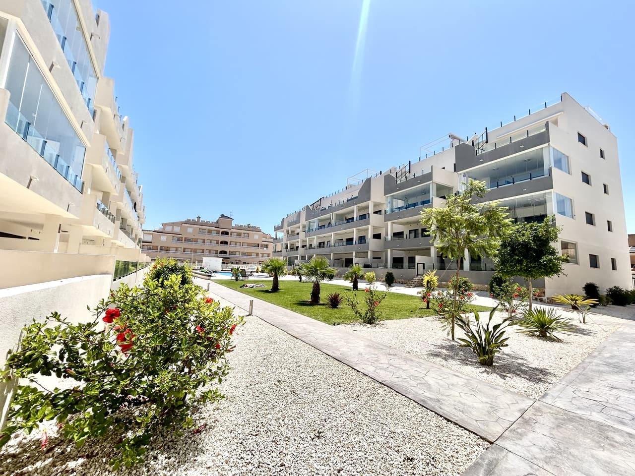 Discover this beautifully presented, spacious apartment located in the highly sought-after area of Los Dolses, perfectly positioned within walking distance to a fantastic selection of amenities, restaurants, shops, and the popular Saturday market. Offering the perfect blend of modern living, comfort, and convenience, this home is ideal as a permanent residence, holiday retreat, or investment opportunity.Built in 2024 by renowned developers Amay, this contemporary apartment offers the quality, style, and energy efficiency expected from a brand-new property. The spacious layout features 3 bedrooms and 2 bathrooms, designed with both comfort and practicality in mind.The highlight of the property is the impressive large private terrace overlooking the beautifully maintained communal gardens and swimming pool. This outdoor space has been enhanced with elegant glass curtains, allowing you to enjoy the terrace all year round — creating the perfect area for relaxing, entertaining, or enjoying the Spanish sunshine in every season.Two of the bedrooms benefit from beautiful sea views, adding a touch of tranquillity and luxury to your everyday living. The property also includes a private underground parking space and a separate storage room, providing valuable additional convenience and space.Located close to everything you need, including local amenities, the Saturday market, and just a short distance from the coast, this apartment offers the ideal lifestyle in one of the Costa Blanca’s most desirable areas.A fantastic opportunity to own a modern home in Los Dolses — combining location, quality, and lifestyle in one exceptional property.