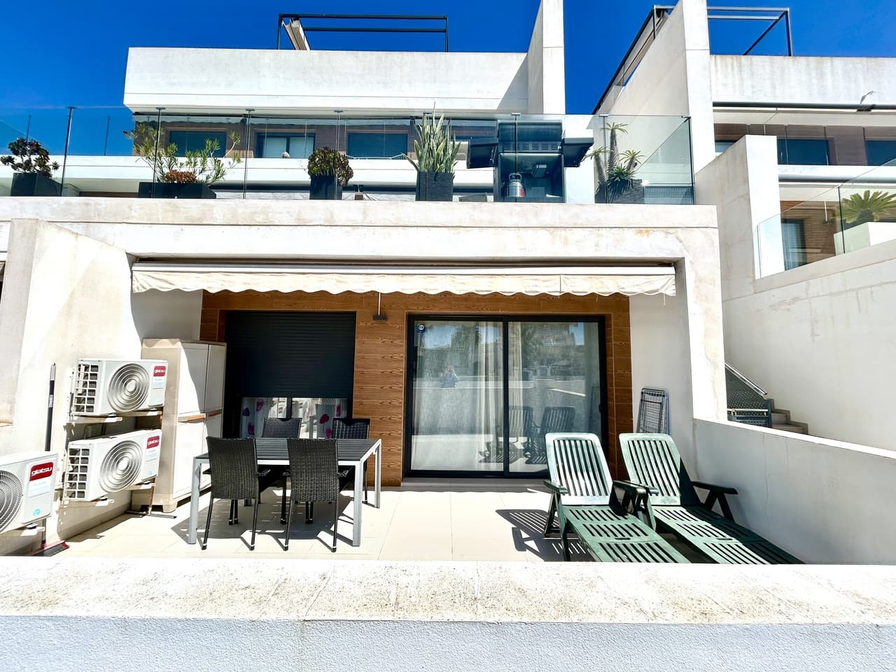 This beautifully presented two-bedroom, two-bathroom ground-floor apartment in Villamartín offers modern living in a bright and sought-after setting. Ideally located just a few metres from La Fuente Commercial Center, with supermarkets, restaurants, and everyday services within easy walking distance, the property combines comfort with exceptional convenience.The apartment enjoys a south-facing terrace overlooking the communal pool, ensuring sunshine throughout the day—perfect for relaxing, entertaining, or al fresco dining.Inside, the home features a contemporary open-plan kitchen flowing into a spacious and light-filled living and dining area. Large sliding doors connect the interior directly to the terrace, creating a seamless indoor–outdoor living experience.The master bedroom includes a private en-suite bathroom, while a second double bedroom is served by a separate family bathroom, making the layout ideal for both residents and guests.The property also benefits from a private parking space and a secure storage room, adding practicality to its stylish design.With its modern finishes, prime location, and excellent communal facilities, this apartment is perfectly suited as a permanent residence, holiday retreat, or high-potential rental investment on the Costa Blanca.