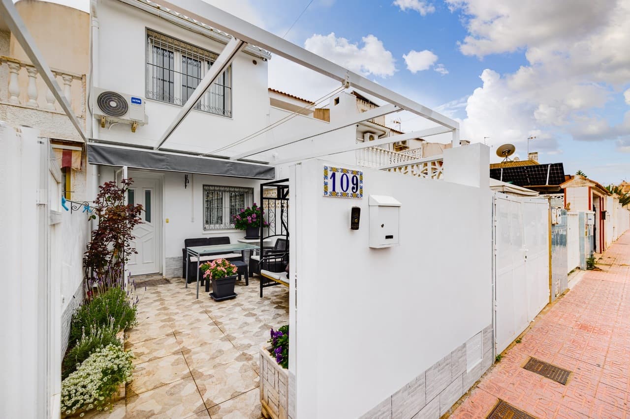 Nestled in the heart of Torrevieja, this charming 3-bedroom, 1.5-bathroom townhouse offers the perfect blend of sunshine, comfort, and Mediterranean living. With sunny gardens at both the front and rear, a private solarium, communal pool, and private parking, it’s an ideal home for holidays, full-time living, or a smart investment on the Costa Blanca.As you step through the gate, you’re welcomed by a bright front terrace — the perfect spot for morning coffee or relaxing afternoons — complete with a convenient awning for shade during the warm summer months.Entering through the front door, you’ll find a welcoming entrance hallway and the first bedroom, a versatile space ideal for a single bed, guest room, or home office. Continuing through the property, you arrive at a spacious and inviting living room that flows naturally into a well-sized kitchen, creating a comfortable space for both everyday living and entertaining.On this ground level there is also a convenient guest toilet, a practical utility room, and direct access to the sunny rear garden. From here you can step straight into the beautifully maintained communal gardens and pool area — perfect for cooling off on warm days.Upstairs, the property offers two generous double bedrooms and a family bathroom. One of the bedrooms provides access to the home’s private solarium, a wonderful sun-drenched space ideal for sunbathing, relaxing with a book, or enjoying warm Mediterranean evenings.With its sunny outdoor spaces, excellent layout, communal pool, and private parking, this delightful townhouse offers the perfect opportunity to enjoy the relaxed lifestyle Torrevieja is known for.