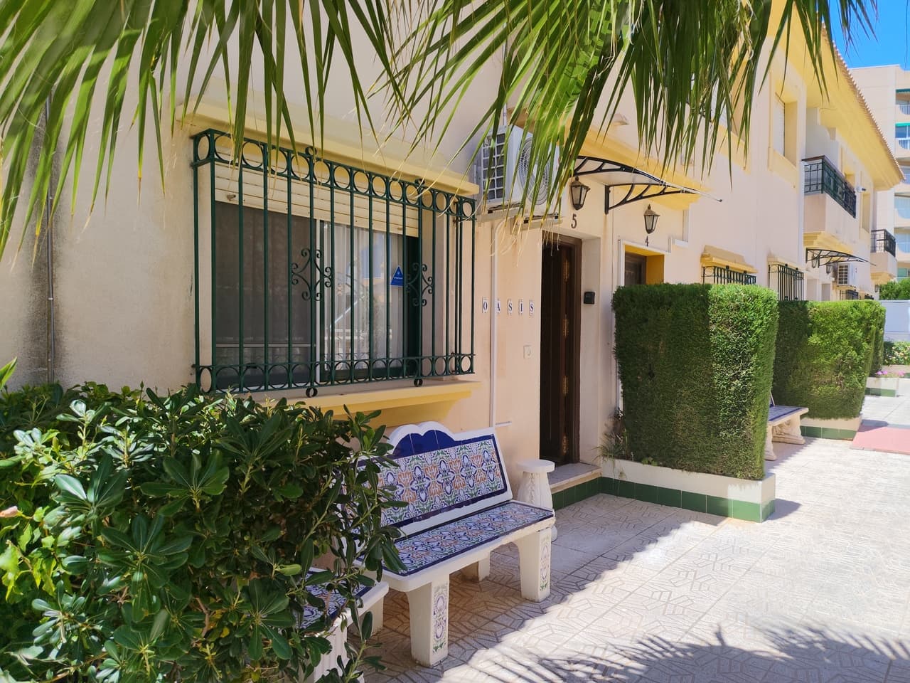 This inviting 3-bedroom, 2-bathroom townhouse is full of classic Spanish charm and warmth across a wonderfully functional multi-level layout. The ground floor opens up to a spacious living area seamlessly connected to a traditional open-plan wooden kitchen via a stylish breakfast bar and feature archway, making it a fantastic social hub for the home. For added convenience, a practical guest bathroom is also located downstairs. Directly off the kitchen, you are greeted by a private, fully tiled terrace, an idyllic backdrop for morning coffees in the Mediterranean sunshine or hosting breezy evening barbecues under the stars.The upper levels are dedicated to rest and relaxation. The first floor hosts cozy, private sleeping quarters, where both bedrooms open out onto their own charming balconies, perfect for enjoying a quiet moment with a cool breeze. Ascending to the top level, you will find the impressive master bedroom, offering a generous layout and an abundance of natural light.As part of an established community, residents also enjoy exclusive access to a beautiful communal pool and beautifully landscaped garden areas, providing a serene oasis for cooling off after a long day in the sun.