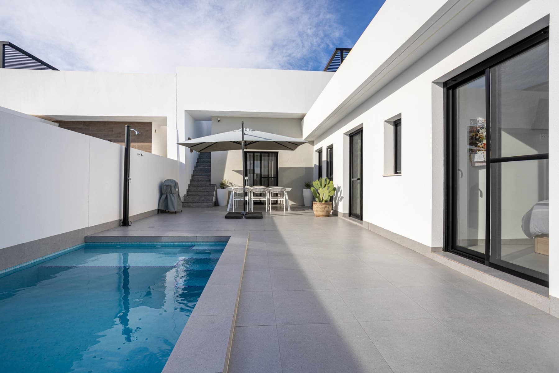 This charming detached villa offers the perfect balance of comfort, privacy, and Mediterranean living, located in a quiet residential area of Torre-Pacheco, just minutes from all amenities.Built on a 151.71 m² private plot, the property has 85 m² of constructed space, all on one level, making it practical, accessible, and easy to maintain. The villa is designed to make the most of natural light thanks to its East orientation, ensuring bright interiors throughout the day.Inside, the home features three spacious bedrooms, all with built-in wardrobes, and two modern bathrooms, one of which is ensuite to the master bedroom. there is also a laundry and extra wardrobe area, very useful yet discreet. The open-plan kitchen flows seamlessly into the living and dining area, creating a welcoming and functional space ideal for both everyday living and entertaining guests. The property is in excellent condition, ready to move into, and is sold fully furnished, including appliances and air conditioning for year-round comfort.Outdoors is where this villa truly shines. The property boasts a private swimming pool, surrounded by a well-proportioned garden area, perfect for relaxing, sunbathing, or enjoying outdoor meals. A covered porch provides a shaded seating area, while the terrace and solarium offer additional space to enjoy the sun, entertain, or simply unwind with open views and privacy. There is a shade area upstairs on the solarium, along with an exterior kitchen, perfect for barbeques. The home also includes private parking within the plot and an intercom system for added security.Prime LocationBeaches: 20 minutesMurcia International Airport: 15 minutesLeisure areas, shops & restaurants: 5 minutesGolf courses: 5 minutesThis property is ideal as a permanent residence, holiday home, or rental investment, thanks to its excellent location, outdoor space, and move-in-ready condition. A fantastic opportunity to enjoy the Costa Cálida lifestyle with comfort, sunshine, and privacy.