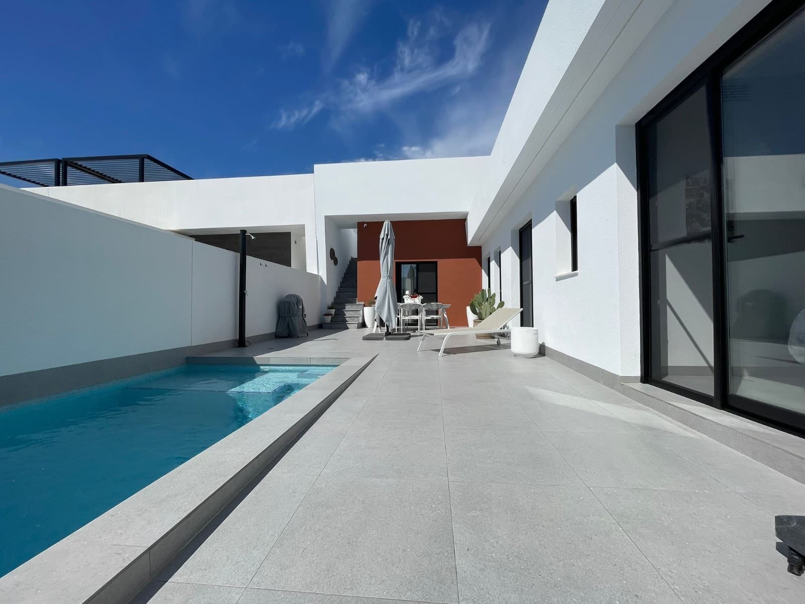 This charming detached villa offers the perfect balance of comfort, privacy, and Mediterranean living, located in a quiet residential area of Torre-Pacheco, just minutes from all amenities.Built on a 151.71 m² private plot, the property has 85 m² of constructed space, all on one level, making it practical, accessible, and easy to maintain. The villa is designed to make the most of natural light thanks to its East orientation, ensuring bright interiors throughout the day.Inside, the home features three spacious bedrooms, all with built-in wardrobes, and two modern bathrooms, one of which is ensuite to the master bedroom. there is also a laundry and extra wardrobe area, very useful yet discreet. The open-plan kitchen flows seamlessly into the living and dining area, creating a welcoming and functional space ideal for both everyday living and entertaining guests. The property is in excellent condition, ready to move into, and is sold fully furnished, including appliances and air conditioning for year-round comfort.Outdoors is where this villa truly shines. The property boasts a private swimming pool, surrounded by a well-proportioned garden area, perfect for relaxing, sunbathing, or enjoying outdoor meals. A covered porch provides a shaded seating area, while the terrace and solarium offer additional space to enjoy the sun, entertain, or simply unwind with open views and privacy. There is a shade area upstairs on the solarium, along with an exterior kitchen, perfect for barbeques. The home also includes private parking within the plot and an intercom system for added security.Prime LocationBeaches: 20 minutesMurcia International Airport: 15 minutesLeisure areas, shops & restaurants: 5 minutesGolf courses: 5 minutesThis property is ideal as a permanent residence, holiday home, or rental investment, thanks to its excellent location, outdoor space, and move-in-ready condition. A fantastic opportunity to enjoy the Costa Cálida lifestyle with comfort, sunshine, and privacy.
