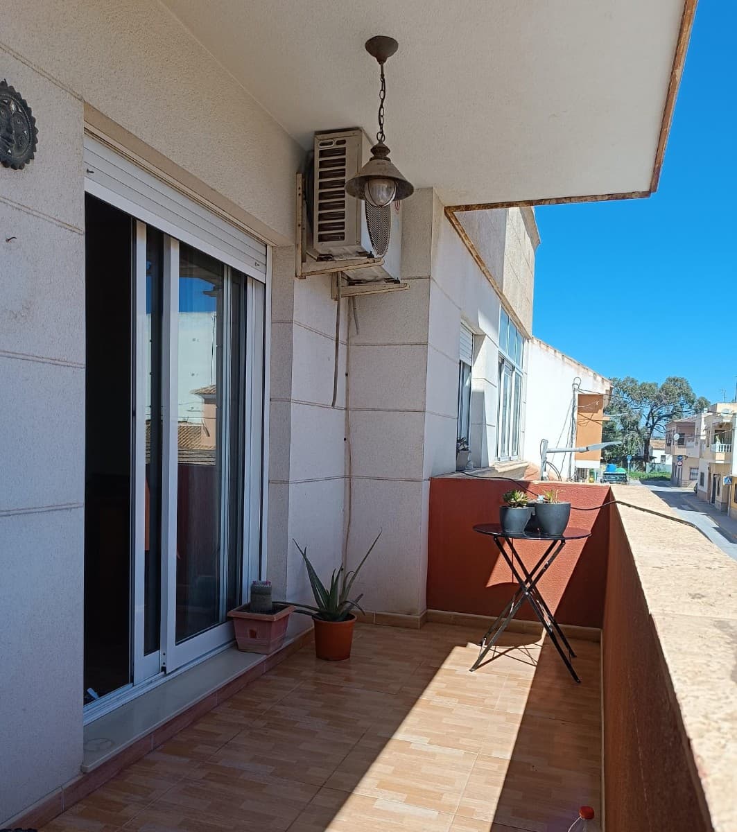 Welcome to a wonderfully spacious first-floor apartment in the charming town of Los Montesinos — a home that instantly invites you to slow down, relax, and enjoy the Mediterranean lifestyle you’ve been dreaming of.As you step inside, you’re immediately greeted by an impressive sense of space and light throughout the generous 100m² interior. Designed for comfortable everyday living, the apartment offers bright and airy rooms that create a warm and welcoming atmosphere from the very first moment. Whether you’re looking for a full-time residence, a holiday escape, or an investment opportunity, this property effortlessly combines comfort, practicality, and style.The inviting living area is the perfect place to relax or entertain, complete with an air conditioning unit for year-round comfort. In addition, the property already benefits from pre-installation ducting, making future integrated air conditioning easy to install if desired. Attractive quality finishes throughout the apartment add a modern and elegant touch to the home.One of the standout features is the exceptionally large independent kitchen, offering an abundance of workspace and storage — ideal for anyone who enjoys cooking, entertaining, or simply appreciating the luxury of a spacious separate kitchen. From here, you also have direct access to an additional private patio area, providing even more outdoor space and practicality, perfect for laundry, storage, or creating your own quiet corner to enjoy the fresh air.The apartment also offers two generously sized bedrooms, both designed to provide a peaceful and comfortable retreat, along with a stylish bathroom featuring a contemporary walk-in shower. Every detail of the home has been thoughtfully arranged to create a relaxed and easy lifestyle.Step outside onto the fantastic private terrace of over 12m² and picture yourself enjoying sunny breakfasts, long lunches, or relaxing evenings with family and friends while soaking up the wonderful Costa Blanca climate. This spacious outdoor area truly extends the living space of the home and is perfect for enjoying outdoor living all year round.Sold fully furnished and including kitchen appliances, the apartment is completely ready for immediate enjoyment — simply bring your suitcase and start living the Spanish dream.Ideally situated in the popular town of Los Montesinos, you’ll have local shops, cafés, restaurants, and everyday amenities all within easy walking distance, while the beautiful beaches, golf courses, and coastal attractions of the Costa Blanca are just a short drive away.This is more than just an apartment — it’s a bright, spacious, and welcoming home where you can truly enjoy the relaxed Mediterranean way of life.