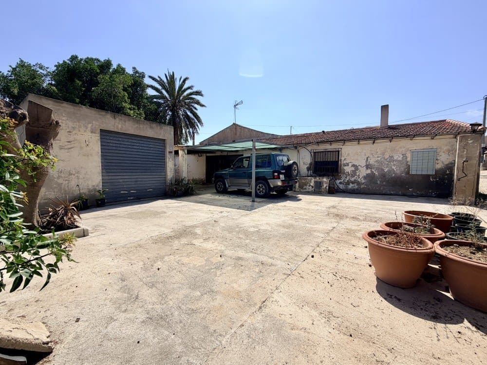 Located in the sought-after area of La Marina del Pinet, this charming country house represents an excellent opportunity for both residential living and investment purposes.The property is situated less than 50 metres from the well-known Camping La Marina, a leisure complex offering a wide range of amenities, including shops, restaurants, recreational areas, children’s activities, and impressive water facilities with slides. This proximity provides a unique added value, combining peaceful surroundings with immediate access to entertainment and services.Furthermore, the house enjoys a prime location just a 10-minute walk from the beautiful natural beaches of El Pinet, renowned for their protected environment, sand dunes and clean waters — perfect for enjoying the Mediterranean lifestyle in a tranquil setting.The property offers 200 m² of built area, comprising:5 spacious bedrooms2 full bathrooms2 bright living roomsIndependent kitchen with fireplaceOutside, the property sits on a generous 1,800 m² plot, featuring:Large courtyardExpansive garden with great potentialBarbecue areaGarage with space for 2 vehiclesThe house requires a full renovation, making it an ideal project to tailor the property entirely to the buyer’s preferences. Importantly, the structure, walls and roof are in good condition.La Marina is a highly desirable area, appreciated for its balance between natural surroundings and local amenities, as well as its proximity to towns such as Elche and Guardamar del Segura, and its excellent transport connections. This makes it a perfect location both for year-round living and holiday enjoyment.