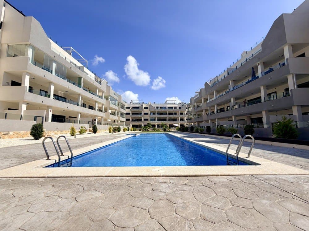 Like new, this bright and modern apartment stands out for its spacious layout and excellent location within a well-maintained gated residential complex featuring a swimming pool and landscaped green areas, perfect for enjoying the Mediterranean lifestyle all year round.The property is located on the second floor (with lift) and offers a total built area of 107 m² (84 m² usable), complemented by a fantastic 25.71 m² east-facing terrace, ideal for enjoying morning sunlight.The interior layout includes:Spacious and bright living-dining roomLarge fully equipped independent kitchen with utility/laundry area3 bedrooms with fitted wardrobes2 fully fitted bathroomsThe apartment is sold fully furnished and equipped, ready to move into, and also includes:Underground parking space (12.73 m²)Private storage room (4.11 m²)Built in 2024, the property is in excellent condition and benefits from features such as air conditioning, individual heating, and adapted exterior access for people with reduced mobility.Situated in a growing and well-established area, surrounded by modern residential developments, it offers a welcoming international environment. All amenities are within walking distance, including town hall, schools, banks, sports facilities, bars, restaurants, and the popular La Zenia Boulevard shopping centre. The area also features a weekly market, golf courses, and excellent transport connections.An ideal opportunity as a permanent residence, holiday home, or investment property!!