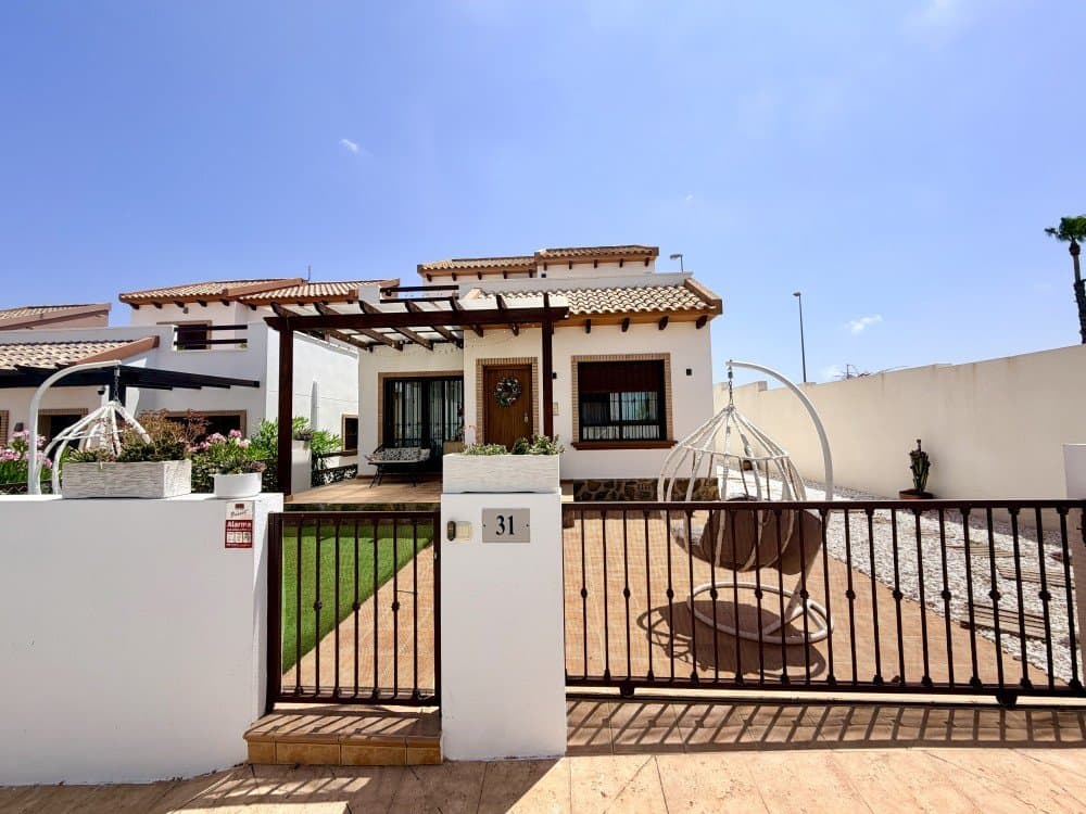 Discover your perfect sunny escape in Rojales, one of the most sought-after locations on the Costa Blanca. This beautifully designed home blends traditional Mediterranean character with elegant, modern interiors, creating a space that feels both stylish and welcoming from the moment you step inside.Ready to move in and finished to an exceptional standard, the property offers a bright, open-plan living area with a contemporary kitchen and dining space ideal for both everyday living and entertaining. Large windows flood the home with natural light, enhancing the sense of space and comfort throughout.The house features three thoughtfully designed bedrooms and two bathrooms. The standout master suite, located on the first floor, boasts direct access to a spacious terrace with stunning mountain and sea views, along with built-in wardrobes and a luxurious en-suite bathroom. Two additional bedrooms on the ground floor provide flexible space for guests, family, or a home office.Step outside and enjoy your own private Mediterranean retreat. The fully landscaped garden, complete with terracotta tiles, decorative stones, and lush plants, offers a peaceful setting to relax and unwind. A covered terrace with a wooden pergola and ambient lighting creates the perfect spot for morning coffee or evening gatherings. The property also includes a private driveway and access to a communal swimming pool.Ideally located just 10 minutes from the golden beaches of Guardamar del Segura and close to the vibrant areas of Torrevieja and La Mata, this home offers the perfect balance of tranquility and convenience. With easy transport links to Alicante and its international airport, everything you need is within reach.Whether you’re searching for a permanent residence, a holiday getaway, or a smart investment, this exceptional property is a rare opportunity to enjoy the very best of Mediterranean living.IBI: 250€/ yearCommunity fees: 50€/ month