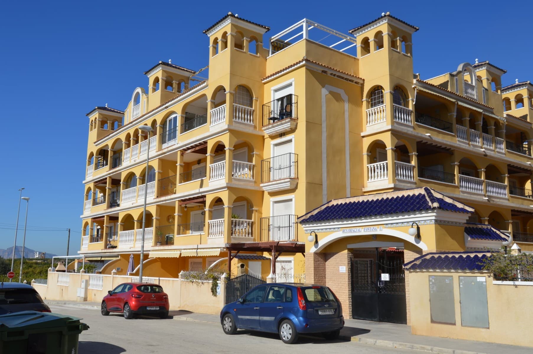 A spacious first-floor apartment located in the sought-after Residencial Fontana 1, in the charming village of Algorfa.This well-presented home offers a larger footprint than most apartments within the building, providing an enhanced sense of space and comfort. The property features a bright open-plan living room and kitchen, designed for modern living and entertaining, with ample natural light flowing throughout. Properties in this development are known for their generous lounge-dining areas and well-equipped kitchens .From the living area, doors lead out to a west-facing private balcony, an ideal spot to relax and enjoy the afternoon sun while taking in pleasant open views across the surrounding countryside and orange groves, a characteristic feature of homes in this area .The apartment forms part of a well-maintained gated community, benefiting from:Lift accessAllocated parking space (often underground)Attractive communal swimming pool and landscaped areas Set in a peaceful yet central location, the development is within walking distance of local amenities while enjoying the tranquillity of a traditional Spanish setting.Overall, this is an ideal property for permanent living, a holiday home, or investment, combining space, views, and excellent communal facilities in one of the most desirable residential complexes in the area.