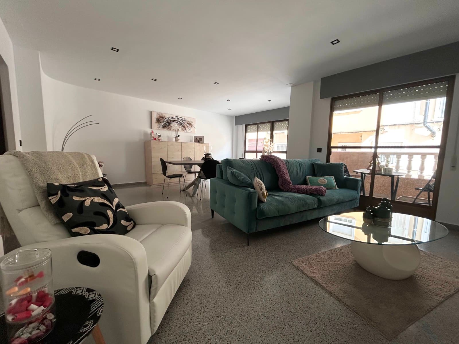 This beautifully reformed and spacious 3-bedroom, 1-bathroom ground-floor apartment is located within a gated community in the peaceful village of Torremendo, offering excellent potential to create an additional independent studio—ideal for visiting family or guests.The property boasts approximately 120 m² of living space and has been fully modernised to provide a bright, comfortable, and contemporary home. It features three bedrooms (two generously sized and one smaller room), a stylishly renovated bathroom, and a walk-in dressing area.Upon entering, you are welcomed into a warm and inviting living space that benefits from plenty of natural light, creating an airy and modern feel throughout. Residents also have access to a communal solarium, perfect for enjoying the Mediterranean climate and surrounding views.A key highlight of this property is the opportunity to add a separate 34 m² studio, offering flexibility for guest accommodation, rental potential, or additional private living space.Situated just a short walk from the Torremendo lake, the apartment is surrounded by beautiful natural scenery, ideal for walking and outdoor activities. The village itself offers a selection of everyday amenities including shops, cafés, and local services, all within easy reach.This is an excellent opportunity for those looking to enjoy a peaceful and authentic Spanish lifestyle, while still being just a short drive from Orihuela and the Costa Blanca coastline.