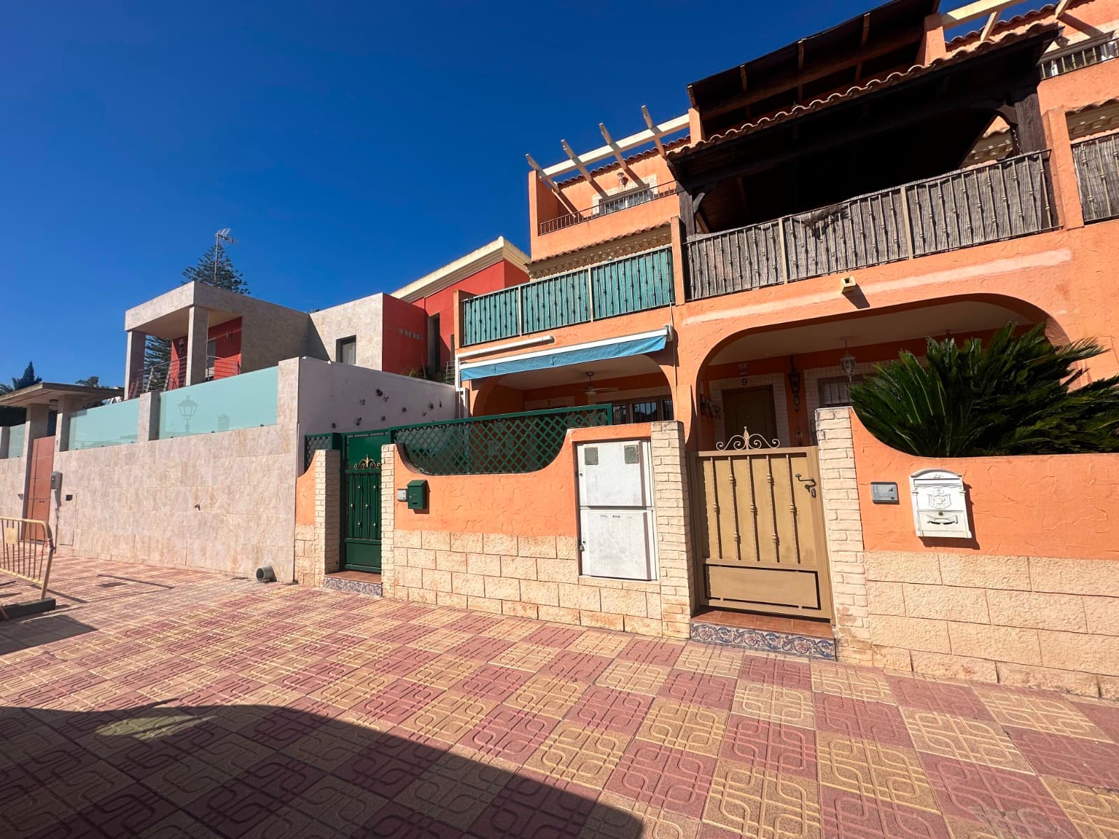 Located in the charming village of Jacarilla, this spacious west-facing townhouse offers generous living across multiple levels and is presented fully furnished, ready to move into.As you enter from the street, you are welcomed by a lovely sunny front terrace — the perfect spot to relax and enjoy the afternoon sun. Inside, the ground floor features a bright living area, a convenient guest toilet, a fully fitted kitchen, and access to a private back patio ideal for outdoor dining or extra storage.The first floor offers two double bedrooms and two bathrooms, including a spacious master bedroom with en-suite bathroom and its own attractive front terrace. A further family bathroom serves the second bedroom.On the top floor, you will find a third double bedroom, another bathroom, a private balcony, and access to a fantastic roof terrace with plenty of space for sunbathing, entertaining, or enjoying the open views.The property also benefits from a large underbuild featuring a private garage and an impressive storage room with potential for a workshop, hobby area, gym, or additional storage needs.This is an excellent opportunity to purchase a spacious and versatile home in a traditional Spanish village, close to local amenities and within easy reach of the beautiful Costa Blanca coastline.