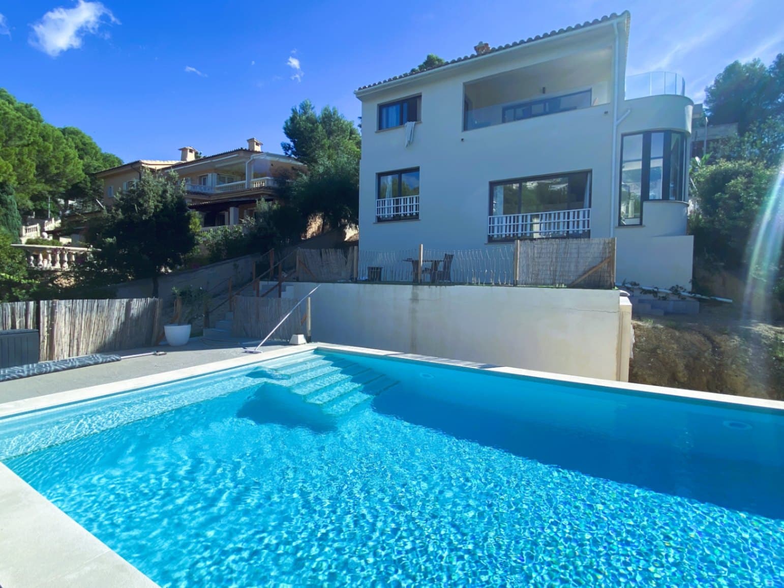 This elegant, modern villa in Costa de la Calma was completely renovated in 2022 and is set in an elevated position, offering breathtaking sea views. Surrounded by a well-maintained garden, mature fruit trees, and with direct access to the sea, it is the perfect retreat for both permanent living and holidays.The entrance to the house is on the ground floor, leading into a bright open-plan living and dining area with an integrated kitchen. From the living room, you access a large terrace with stunning panoramic views of the sea.Upstairs you’ll find three bedrooms, each with its own en-suite bathroom. The master bedroom features a spacious walk-in wardrobe, a large bathroom with sea views, and an adjoining office. Two additional bedrooms also enjoy panoramic sea views.At the back of the house is a spacious pool area, ideal for relaxing or entertaining, with space for gardening, barbecues, and other outdoor activities. Next to the pool is a fully equipped guest apartment with kitchen.The property also includes a large garage, two storage rooms, and a guest toilet. Located just one minute’s walk from the beach, this villa is a perfect getaway. Costa de la Calma is a peaceful area in the municipality of Calvià, in southwest Mallorca. It is known for its marinas, golf courses, international schools, beautiful bays, and excellent infrastructure.Palma is a 20-minute drive away, and the airport just 25 minutes.Disclaimer: Certain information contained herein is derived from information provided by owners / collaborators. All information provided is deemed reliable, but is not guaranteed to be accurate and should be independently verified.