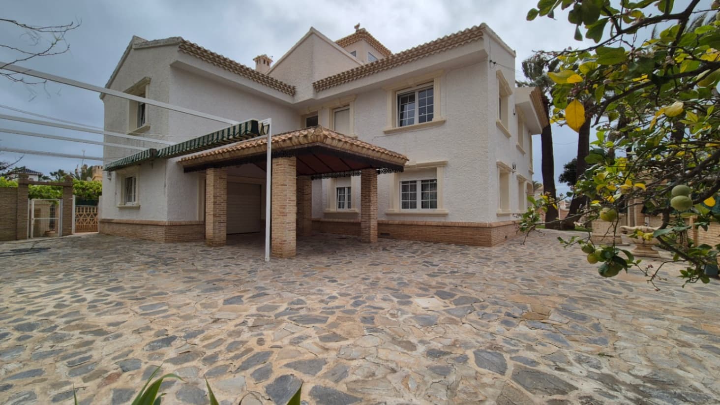 Nestled on a private street lined with exclusive mansions, this stunning property in Cabo Roig exudes the luxurious charm and sophistication of a Miami-style estate. The expansive garden offers a serene escape, featuring a small basketball court for active moments and plenty of space for relaxation or entertainment.A highlight of the property is the enclosed pool area, complete with a stylish meeting space designed for dining and gatherings. The area is sheltered by a roof yet remains open to the surrounding views, allowing for an al fresco dining experience that feels both intimate and expansive.Inside, the mansion boasts six generously sized bedrooms, each a peaceful retreat with ample space to accommodate a large, multi-generational family. The five beautifully designed bathrooms ensure comfort and privacy for every guest.The grand living room features rustic furniture that blends effortlessly with the home's modern architectural style, creating a warm and inviting atmosphere. The fully refurbished kitchen is a chef's dream, with brand-new, state-of-the-art appliances and spacious countertops that invite culinary creativity.This luxurious mansion offers the perfect balance of modern elegance and timeless comfort, making it the ultimate setting for family gatherings, entertaining, or simply unwinding in style.