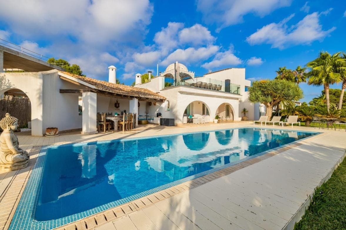 Embrace a life of coastal serenity in this distinguished residence, perfectly positioned on the second sea line within the coveted enclave of Sol de Mallorca . Set against a backdrop of azure waters and lush pine groves, this estate offers a rare vantage point—unobstructed, panoramic views of the Mediterranean that remain preserved by the surrounding natural landscape.The ResidenceSpanning an impressive build of 419 m² , the villa is a masterclass in effortless Mediterranean living. The interiors are defined by an expansive, light-filled floor plan where the boundaries between indoor elegance and outdoor allure disappear. Every corner of the home has been curated with a sophisticated aesthetic, sold fully furnished to ensure an immediate transition into a lifestyle of luxury.The layout features:Four palatial bedrooms , each serving as a private retreat.Four contemporary bathrooms finished with high-end fixtures.Seamless flow between the designer living areas and the sea-facing terraces.The GroundsThe villa is situated on a generous 1,434 m² plot , offering an oasis of total privacy. The exterior is anchored by a shimmering private swimming pool, framed by sun-drained lounging areas and manicured gardens. Whether hosting a sunset soirée or enjoying a quiet morning coffee, the constant presence of the sea provides a soothing soundtrack to daily life.The LocationSol de Mallorca remains one of the island's most prestigious "best-kept secrets." Known for its tranquility and proximity to the crystalline waters of Portals Vells and Cap Falcó, it offers a refined balance of seclusion and accessibility. Renowned marinas, championship golf courses, and world-class dining are all within a short coastal drive.