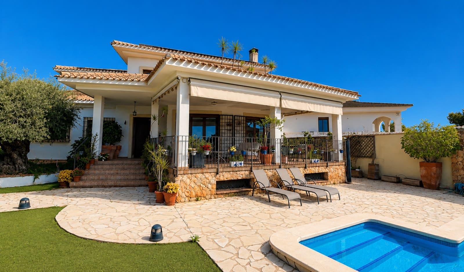This exceptional Mediterranean-style villa is ideally located just 800 metres from the sea, in one of the most prestigious residential enclaves of Dehesa de Campoamor, on the sought-after Orihuela Costa. Combining expansive living spaces, complete privacy, and high-end finishes, the property is perfectly suited as a permanent residence, an elegant holiday home, or a luxurious coastal retreat.Set on a private plot of 725 m², the villa offers an impressive 450 m² of built living space distributed across three levels: basement, ground floor, and first floor. Its south-facing orientation უზრუნველყოფ ensures abundant natural light throughout the day while allowing year-round enjoyment of the Mediterranean climate.Originally built in 2006, the property was fully renovated in 2020. This comprehensive upgrade included new bathrooms, redesigned bedrooms, and a completely modernised kitchen, achieving contemporary comfort while preserving the villa’s distinctive Mediterranean charm.The residence features a total of 7 bedrooms and 5 bathrooms, thoughtfully distributed across the three levels:Basement: 2 bedrooms and 1 bathroomGround floor: 3 bedrooms and 2 bathroomsFirst floor: 2 bedrooms and 2 bathroomsThe upper level hosts a stunning 32 m² master suite, bathed in natural light and complemented by a private en-suite bathroom and a spacious walk-in wardrobe, creating a refined and tranquil private sanctuary.The outdoor spaces are designed to fully embrace Mediterranean living. A beautifully landscaped garden with mature trees and flowering plants surrounds a private 27 m² swimming pool—perfect for relaxing in total privacy or entertaining guests in style.The property also includes a large garage with capacity for three full-size vehicles.At the heart of the home is a generous 23 m² kitchen, completely renovated in 2020 and fitted with premium furnishings and finishes from the renowned European brand Schmidt. It offers a perfect blend of elegance, space, and functionality for both everyday living and entertaining.Additional features include:Air conditioning (hot and cold) on the ground and first floorsSolar panel system producing approximately 10 kW/h, enhancing energy efficiencyElectric vehicle charging stationEnergy certificatePerimeter alarm system with video surveillanceCorner plot position, providing enhanced privacyTerracotta flooring throughout, reinforcing the Mediterranean characterHandcrafted wrought-iron railings from Toledo, adding distinctive architectural detailThe villa also benefits from access to an exclusive private community area reserved for homeowners in Dehesa de Campoamor, offering excellent leisure and social facilities, including:Three tennis courtsOne paddle courtTwo football pitchesSemi-Olympic swimming poolPrivate residents-only cantina/restaurant, fostering a welcoming and social community atmosphereThis is a rare opportunity to acquire a spacious, fully renovated Mediterranean villa close to the sea in one of the most desirable areas of the Costa Blanca—offering an exceptional combination of comfort, sustainability, privacy, and premium lifestyle amenities.