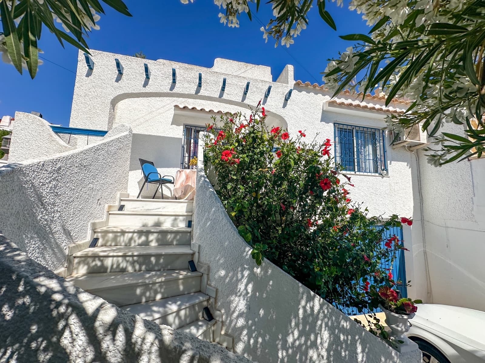 Step into a beautifully renovated semi-detached villa in the highly desirable area of Los Balcones, where timeless Mediterranean charm blends effortlessly with contemporary design and carefully chosen premium finishes. Every corner of this home has been thoughtfully updated to create a warm, elegant, and functional living environment.The bright and welcoming living area is filled with natural light thanks to expansive windows that create a seamless connection between the indoors and the outdoor terrace. Just outside, the private swimming pool invites you to unwind at any time of day, whether it’s a refreshing morning dip or a relaxing evening under the stars. For added peace of mind and convenience, the pool is fitted with an electrically operated safety barrier, and pet owners will appreciate the dedicated dog-washing station.One of the bedrooms enjoys direct access to the pool terrace, offering the perfect setting to start the day with coffee in the morning sun. Inside, modern comforts continue with features such as a stylish wine cooler, ensuring your favorite bottles are always perfectly chilled and ready to enjoy.The outdoor spaces are designed for both relaxation and entertaining. The lush garden includes mature fruit trees that provide natural shade and a charming Mediterranean atmosphere, while multiple seating areas allow you to enjoy the sun throughout the day. An inviting outdoor bar and barbecue area create the ideal setting for unforgettable evenings with family and friends. A private garage adds practicality and convenience to everyday living.At the top of the home, the spacious rooftop terrace offers panoramic views stretching across the salt lake and out towards the Mediterranean Sea. Bathed in sunshine from sunrise to sunset, this is a place made for relaxing, entertaining, and embracing the Costa Blanca lifestyle all year round.Located in a peaceful yet well-connected neighborhood, the property is close to restaurants, shopping, essential services, and some of the area’s most beautiful beaches. This is more than just a home — it is a lifestyle defined by comfort, quality, and effortless Mediterranean living.Welcome to a property where modern elegance, thoughtful features, and outdoor living come together in perfect harmony.