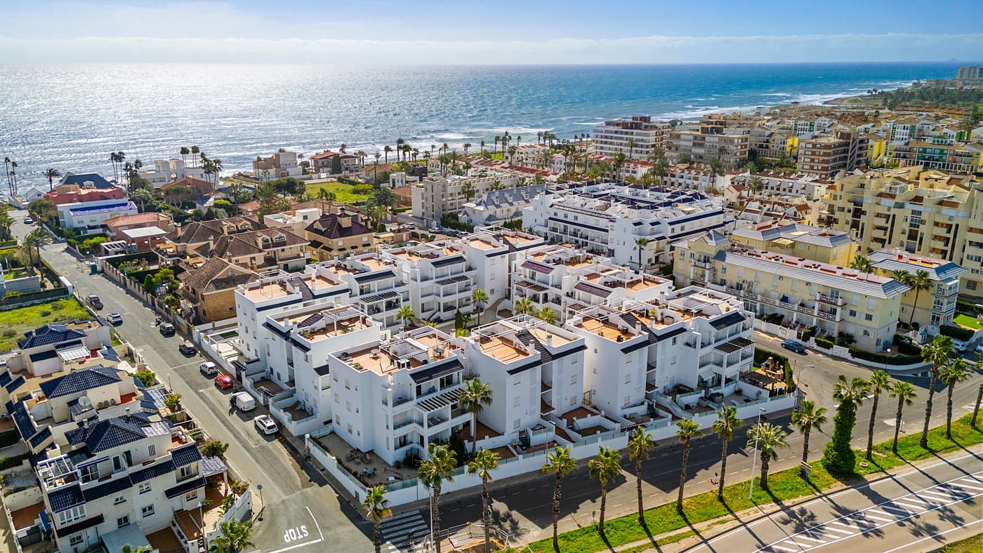 This inviting penthouse apartment from 2005 is located on the 2nd floor in a well-maintained, gated complex with a total of 66 properties. You get a home in very good condition with a well-designed layout, plenty of outdoor space, and a location that ranks among the best in the area.The apartment offers two spacious bedrooms with built-in wardrobes and two bathrooms, one of which is ensuite to the master bedroom. The bathroom in the master bedroom was fully renovated in 2025, giving the property a modern and updated feel.Upon entering the apartment, you are welcomed by an entrance hall with the kitchen located to the right. The kitchen provides ample storage space. From here, there is access to a practical patio area with, among other things, a washing machine. To the left of the entrance, you will find the bright and spacious living room with plenty of space for both a dining area and a lounge.From both the living room and the master bedroom, there is access to a cosy east-facing terrace overlooking the beautiful communal pool area. Here you can enjoy the morning sun in peaceful surroundings, and a side awning provides additional privacy.From the terrace, a staircase leads up to a large and private rooftop terrace, which truly completes the property. Here, the sun can be enjoyed all day, with the option to relax in the shade under the pergola. From the rooftop terrace, there are lovely views of the town and, not least, the characteristic pink salt lake of Torrevieja. There is also a practical storage room on the rooftop.The apartment includes a private parking space in the underground garage.The property is a non-smoking apartment and is generally well maintained. There is air conditioning in both bedrooms as well as in the living room. The air conditioning units in the living room and guest bedroom are approximately 3.5 years old.The communal areas of the complex were renovated, and the entire development was repainted in 2023, giving it a neat and well-kept appearance.The location is excellent. Supermarkets such as Aldi and Lidl are just approximately 260 metres from the property, and there is a bus stop at a similar distance. The sea can be reached within a few minutes’ walk – only 300 metres away. In addition, there is a short distance to both Torrevieja town centre and Punta Prima, offering easy access to restaurants, cafés, and local amenities. Alicante Airport is approximately 46 km away, and there is easy access to the main road N332.All in all, this is a wonderful penthouse offering comfort, views, and a highly attractive location – ideal as both a holiday home and a permanent residence.