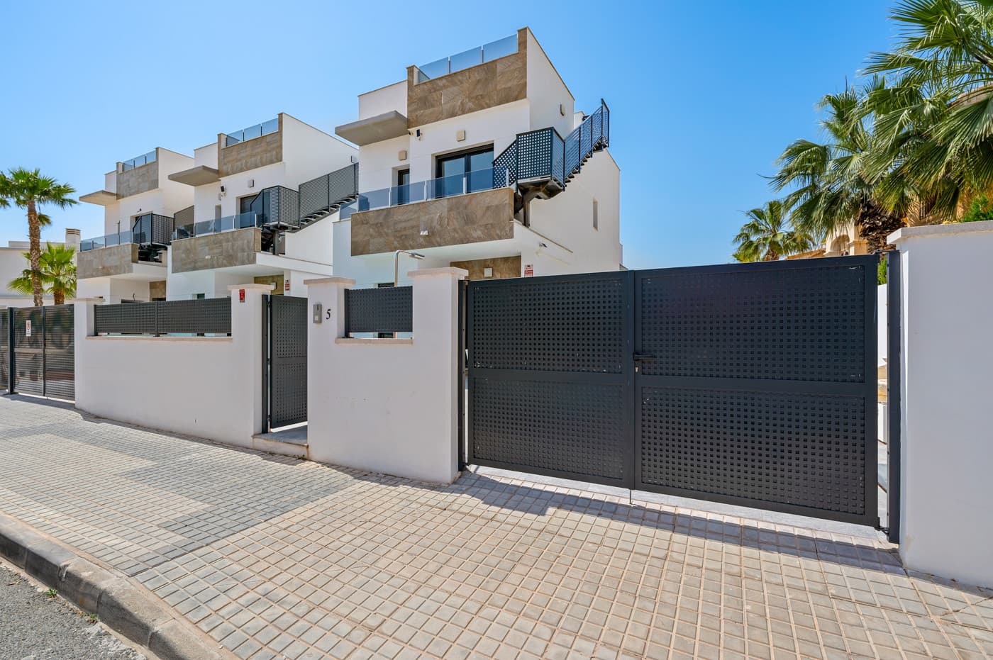 Are you dreaming of a modern villa in the sun, where everything is brand new and ready to move into?This beautiful villa from 2024, located in Torreta, Torrevieja, is presented in excellent condition and is ideal for those looking for a stylish, turnkey home on the Costa Blanca.The property is built in a modern and timeless design over two floors, with a strong focus on light, space, and functionality. On the ground floor, you are welcomed into a bright and inviting living area with an open-plan kitchen connected to the lounge. Large windows provide plenty of natural light and create a seamless transition to the terrace and pool area, where indoor and outdoor living blend perfectly.The villa offers three spacious bedrooms and three bathrooms, with one bedroom and bathroom conveniently located on the ground floor. On the first floor, you will find two additional bedrooms, both with en-suite bathrooms and access to terraces where you can enjoy the outdoor lifestyle. At the top, a large rooftop terrace awaits, offering plenty of sunshine and space for relaxation.Outside, you have a private and easy-to-maintain garden with your own swimming pool and cozy terrace areas, perfect for enjoying the sun all day long. There is also private parking on the plot.The property is sold fully furnished and with installed air conditioning, allowing you to move in and start enjoying life in Spain from day one.The location in Torreta is both მშვიდ and central. From here, you can easily cycle or walk to the popular Playa de los Náufragos via pedestrian and bike paths for most of the way, if you prefer not to drive. At the same time, the beautiful pink salt lake is just a short walk away, offering a unique natural experience right on your doorstep. You are also close to supermarkets, restaurants, and the popular Habaneras shopping center. Torrevieja’s charming town center and promenade are just a few minutes away, and the area is known for its mild Mediterranean climate with sunshine all year round. Alicante Airport is approximately a 40-minute drive away.Here you get a nearly new villa from 2024 in a modern style, with an attractive location close to both the beach and nature – perfect as a holiday home, permanent residence, or investment.