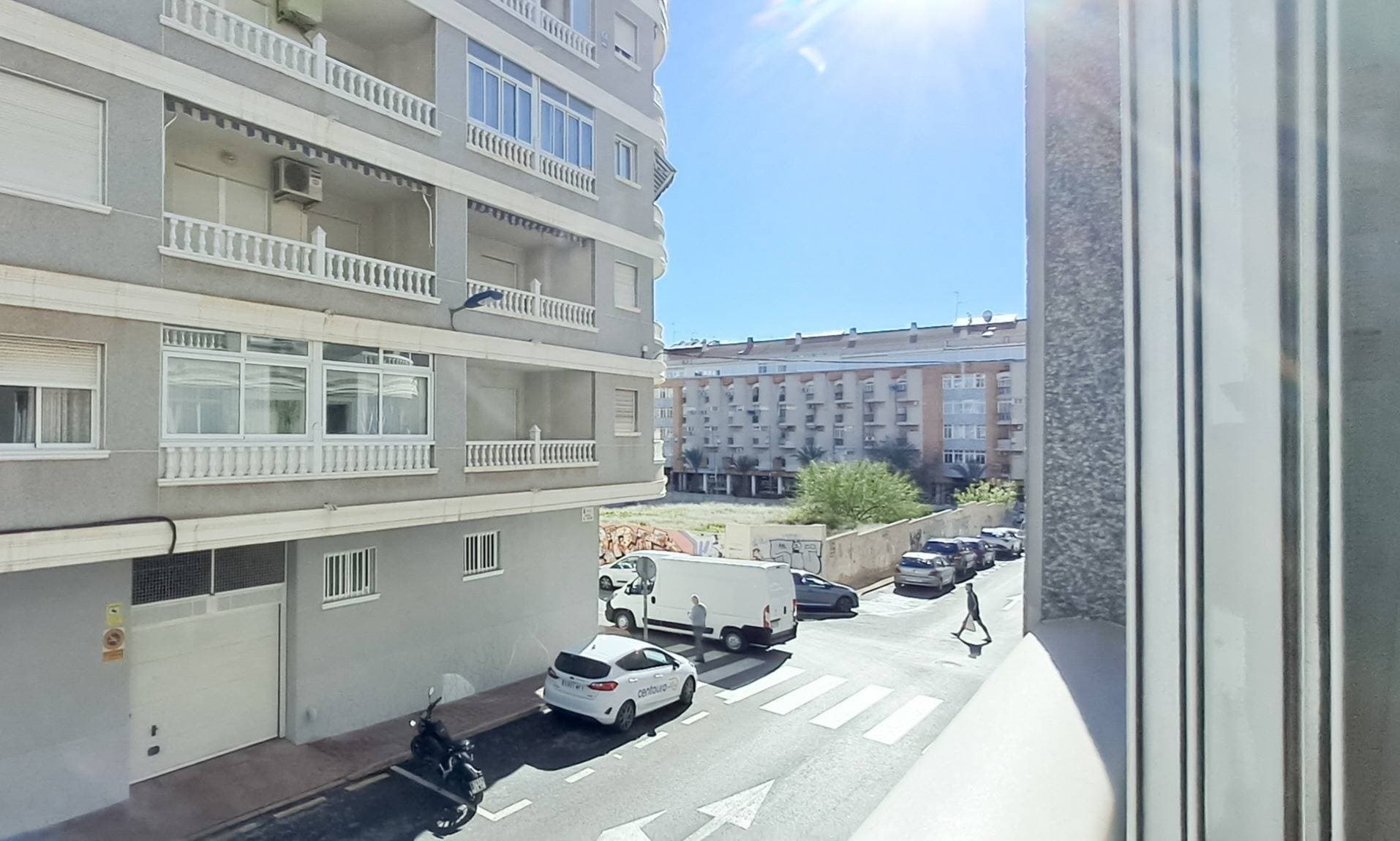 This wonderful Torrevieja city-center apartment features 2 bedrooms and a generously sized bathroom with a walk-in shower. The building offers a large rooftop terrace for residents to enjoy, providing panoramic views over Torrevieja all the way to the sea. With only 550 meters to the nearest beach, the location is excellent, placing all essential services and amenities within easy walking distance. It features a spacious and bright living room with a glazed terrace, a fully equipped independent kitchen, and a convenient laundry and storage area. The property offers 2 bedrooms with built-in wardrobes, electric adjustable beds, and 1 bathroom with a walk-in shower. It also includes air conditioning with heating and cooling for year-round comfort. Optional parking space available just 50 meters from the property. An excellent opportunity both as a permanent home or as a holiday investment in one of the best areas of Torrevieja. This corner-lot building is a well-maintained community from the early 2000s, and stepping outside brings you directly into the vibrant city and close to the sea. Book your viewing now.