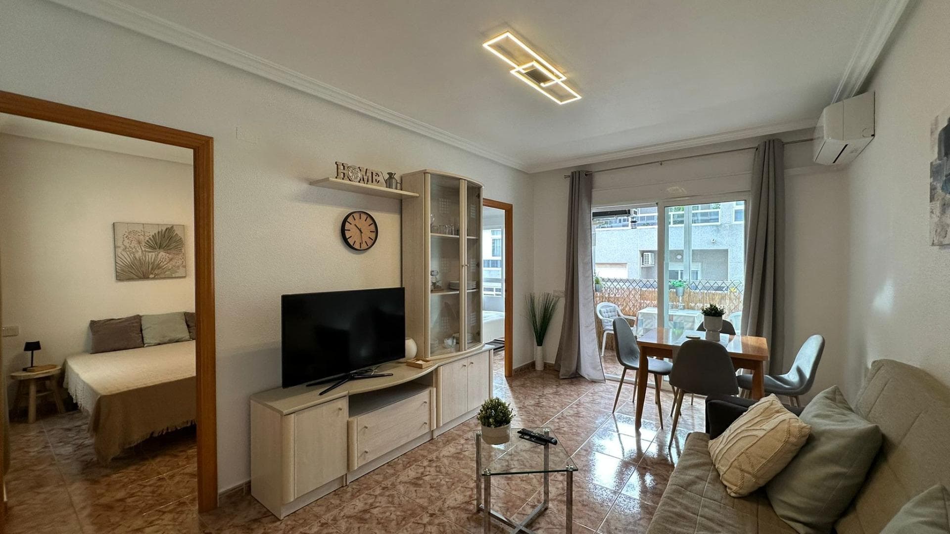 This two-bedroom apartment with a terrace, located in the heart of Torrevieja, is the ideal home for those who want to experience city life with maximum comfort. Its central location allows for a practical, dynamic, and highly functional lifestyle, with everything you need just a few minutes' walk away. The moment you step inside, you'll feel a welcoming home, ready to move into from day one, thanks to its fully furnished sale. This makes moving in incredibly easy for the new owners, who will only need to bring their personal belongings to start enjoying their new home. The apartment's layout encourages comfortable and organized living, with spaces designed for sharing moments with family, entertaining guests, and finding quiet corners at the end of the day. The living room is the heart of the home, a space where everyday activities converge: relaxing on the sofa, watching a movie, chatting, reading, or simply unwinding. From here you access the terrace, one of the apartment's greatest assets. It acts as a natural extension of the living area and multiplies its potential uses, especially in a location with so many hours of sunlight and pleasant temperatures for much of the year. The terrace becomes a true outdoor haven within the urban environment, a perfect spot to enjoy leisurely breakfasts, al fresco dining, or moments of reading with the sea breeze in the background. It's the ideal place to create a small personal oasis, with plants, warm lighting, and some outdoor furniture that invites you to spend time outside. Whether on mild winter mornings or long summer afternoons, this terrace becomes the perfect setting to enjoy the Mediterranean climate without leaving home. For those who value having a private outdoor space right in the heart of the city, this feature offers an added bonus that's hard to find. The fact that the apartment is being sold furnished adds great convenience, especially for those looking for a move-in ready home or a property to rent out. The furniture allows you to easily visualize how the space is lived in, how the different areas are distributed, and how they integrate into daily life. This advantage eliminates the need to invest time and resources in decorating from scratch, minimizing the adaptation period. For an investor buyer, it also represents an opportunity to put the property into operation immediately, whether as a long-term rental or as a holiday home, taking advantage of Torrevieja's high demand year-round. The two bedrooms provide versatility to the apartment, allowing it to adapt to different lifestyles and needs. A family can have a master bedroom and a children's bedroom; a couple can convert one of the bedrooms into a guest room or an office; someone who works from home can combine rest and productivity without sacrificing comfort. This flexibility makes the property attractive to a wide range of profiles: young couples, small families, people looking for a second home near the sea, or even those who want to downsize without giving up having an extra room for various uses. The comfortable and functional bathroom is integrated into the home as an essential element of daily life, designed to offer comfort and practicality. Having a well-designed and comfortable bathroom is key to daily life, especially in a home shared by several people. A good layout, with separate areas for the shower and other fixtures, contributes to a smooth morning and evening routine.