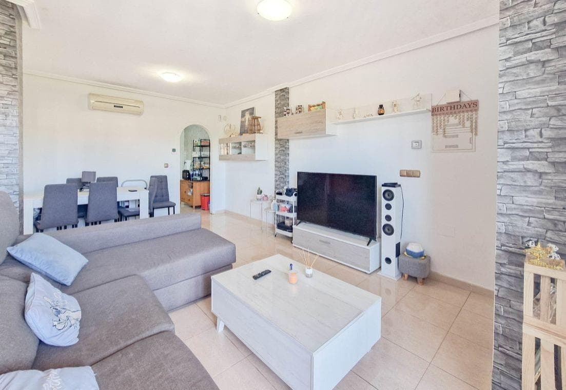 A magnificent opportunity has arisen to purchase an exclusive penthouse situated in the prestigious Lomas de Cabo Roig area, one of the most sought-after residential areas on the Orihuela Costa. Located at the top of the N-332 national road, this setting offers an ideal combination of tranquillity, privacy and excellent links to the main towns and amenities in the area. The property’s location is particularly noteworthy, being approximately two and a half kilometres from the sea, allowing you to enjoy the proximity of the beaches without sacrificing a more relaxed and less crowded residential environment. This feature makes Lomas de Cabo Roig a highly sought-after area for both permanent residents and those seeking a second home on the Mediterranean coast. The south-facing penthouse enjoys excellent natural light throughout the day, benefiting from optimal sun exposure that brings warmth and comfort to the interior spaces. This orientation is particularly sought-after in the property market, as it maximises the use of natural light and improves the home’s energy efficiency. In terms of layout, the property features two bedrooms, both of a suitable size and designed to offer comfort and functionality. These spaces are ideal for both rest and adaptation to different needs, whether as master bedrooms, guest rooms or even as a home office for remote working. The full bathroom, well-maintained and equipped, has a practical layout that meets the demands of daily use. The penthouse forms part of a residential community featuring a communal swimming pool, a feature that adds significant value to the property. This communal space offers an ideal setting for leisure and relaxation, particularly during the warmer months, allowing residents to enjoy the Mediterranean climate in a well-maintained and pleasant environment. In addition to its interior features, the fact that it is a penthouse adds an extra touch of exclusivity, offering greater privacy, better views and a general sense of spaciousness. This type of property is particularly sought after by those who value peace and independence within a residential setting. The Lomas de Cabo Roig area also stands out for its proximity to a wide range of amenities, including supermarkets, restaurants, shopping centres, sports facilities and golf courses, ensuring an excellent quality of life. Furthermore, its good connections to other nearby towns and its accessibility make this location a strategic spot along the Alicante coast. Overall, this penthouse represents a highly attractive opportunity as a primary residence, holiday home or property investment, thanks to its prime location, south-facing aspect, functional layout and the amenities offered by the community in which it is situated. In short, this is a property that combines location, comfort and potential, ideal for those seeking to enjoy the Mediterranean lifestyle in an exclusive and well-established setting.