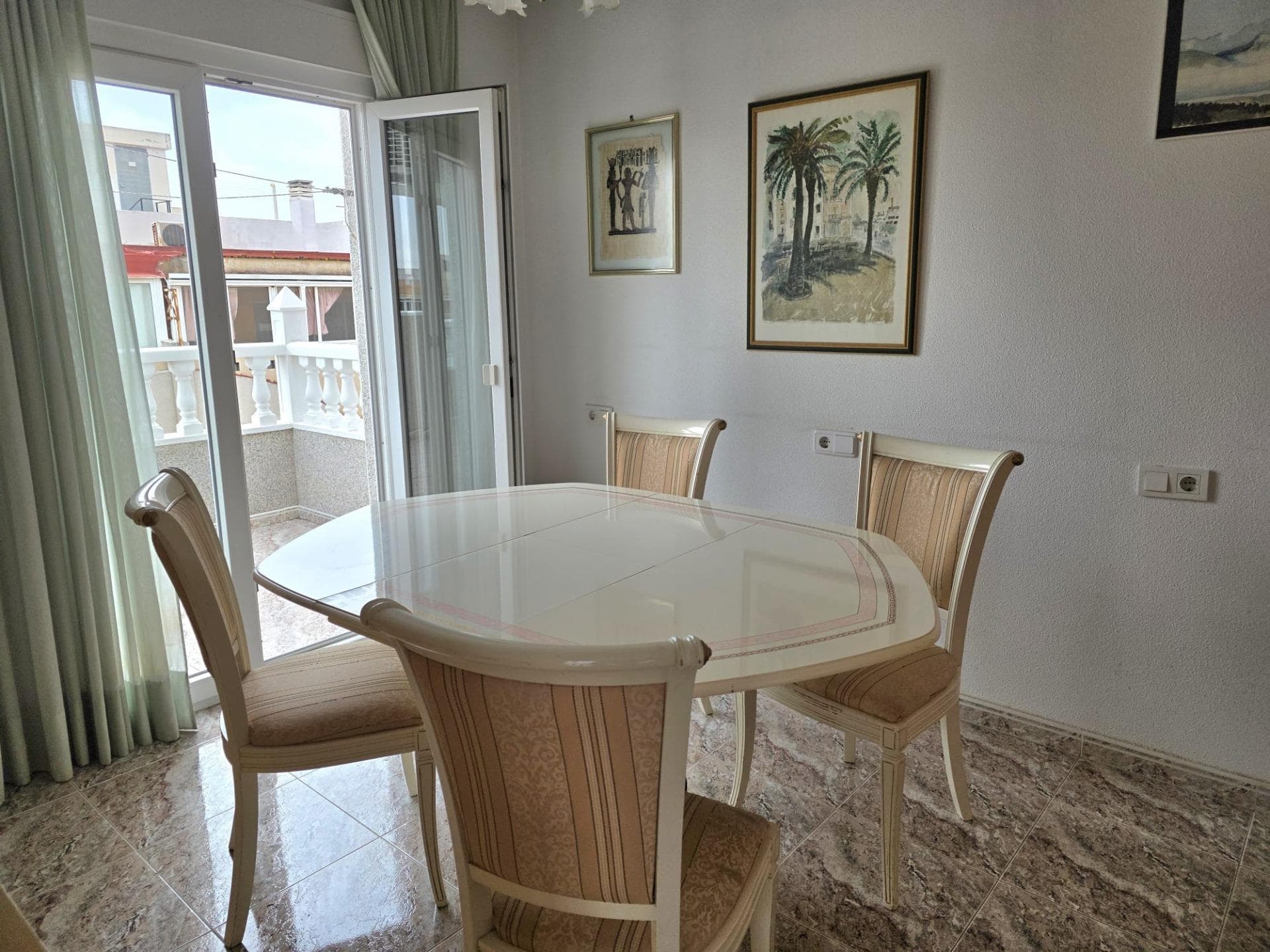 We are pleased to present a truly exceptional property: an exclusive corner penthouse that stands out for its unique design, prime orientation and stunning wrap-around terrace. Located in one of the most sought-after areas of Torrevieja, just 200 metres from the iconic Playa del Cura, this property combines all the elements needed to enjoy a Mediterranean lifestyle centred on light, space and privacy. The property enjoys a south-east facing aspect, considered one of the most sought-after in the property market, as it guarantees excellent natural light throughout the day, as well as optimal cross-ventilation that ensures thermal comfort in all seasons. This feature, combined with its status as a corner penthouse, provides a sense of independence and exclusivity that is hard to find in similar properties. Undoubtedly, one of the most distinctive features of this property is its spectacular corner terrace, a spacious outdoor area that completely surrounds the property. This terrace not only multiplies the possibilities for outdoor enjoyment but also ensures that virtually every room in the property has direct access to or a visual connection with the outdoors. This design provides exceptional natural light and enhances the sense of spaciousness, creating a unique atmosphere where the interior and exterior blend harmoniously. The interior layout has been carefully designed to offer functionality and comfort. The property features three bedrooms, all fitted with built-in wardrobes that maximise storage space. The master bedroom stands out for its spacious double wardrobe and en-suite bathroom with a shower tray, offering added comfort and privacy. The bedrooms benefit from excellent insulation thanks to the double-glazed aluminium folding doors, and two of them are external, with direct access or a view onto the terrace, further enhancing their brightness and connection with the surroundings. The separate, generously sized kitchen is a functional and bright space, thanks to its window opening directly onto the terrace. It features a spacious worktop that allows for comfortable cooking, making it a practical and pleasant space for everyday use. The separate, air-conditioned living room, of optimal dimensions, is one of the property’s standout features. Its direct access to the terrace via a large window fosters a seamless connection with the outdoors and maximises the influx of natural light. Its south-east facing orientation makes it a particularly sunny and cosy space, allowing for a clear distinction between the dining area and the relaxation or television area. The building in which the property is located has adapted access, free from architectural barriers, facilitating entry for people with reduced mobility via a flat and convenient entrance from the main hallway. As for the extras, it is worth noting the excellent condition of the property, as well as the presence of a practical aluminium storage cupboard on the terrace, ideal for additional storage. Furthermore, the terrace has awnings installed around its entire perimeter, allowing you to regulate the amount of sunlight and enjoy the outdoor space at any time of day. The location is, without a doubt, another of this property’s great assets. In addition to its proximity to Playa del Cura and the seafront promenade, it is surrounded by a wide range of amenities, including shops, restaurants, public transport —with a bus stop and station nearby— as well as healthcare facilities such as the well-known La Loma health centre. The area also offers a comprehensive range of educational facilities, with schools and colleges covering all stages of education, from nursery to secondary school. It is also close to various shopping areas and other local beaches. Overall, this penthouse represents a unique opportunity in the property market, combining a prime location, spaciousness, natural light, high-quality construction and an extraordinary outdoor space. It is an exclusive pr