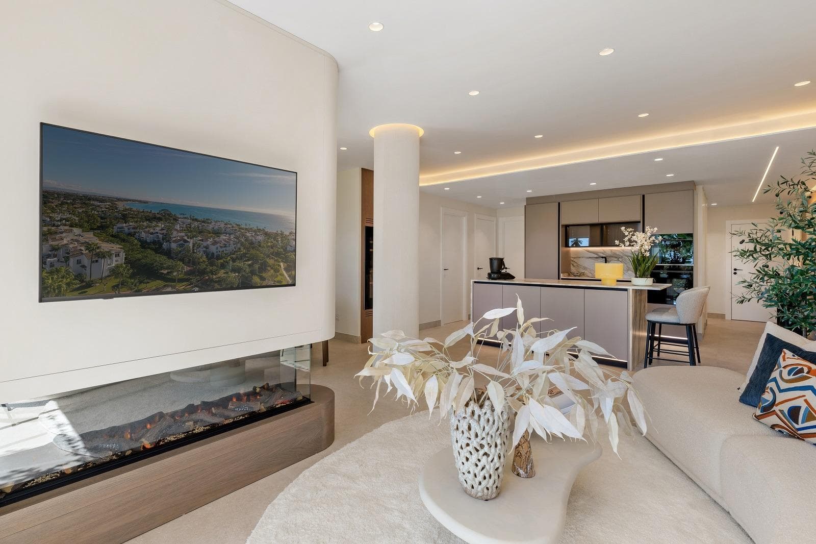 Perfectly positioned on Estepona’s New Golden Mile, this exclusive beachfront community offers a serene atmosphere with lush gardens and sparkling pools. Combining Andalusian charm with modern comfort, it provides direct beach access and is just moments away from top golf courses and restaurants. Just steps from the Mediterranean, this brand-new 3-bedroom apartment is set within a secure, resort-style complex. The bright, open-plan living and dining area—featuring a cozy fireplace—flows seamlessly onto a generous southwest-facing terrace with spectacular sea views. The modern kitchen blends style and function with premium German appliances and a Thermomix. Three spacious, elegantly finished bedrooms are accompanied by contemporary bathrooms. A separate glass-enclosed office, a dedicated laundry area, and warm, sunlit interiors complete this refined coastal home.