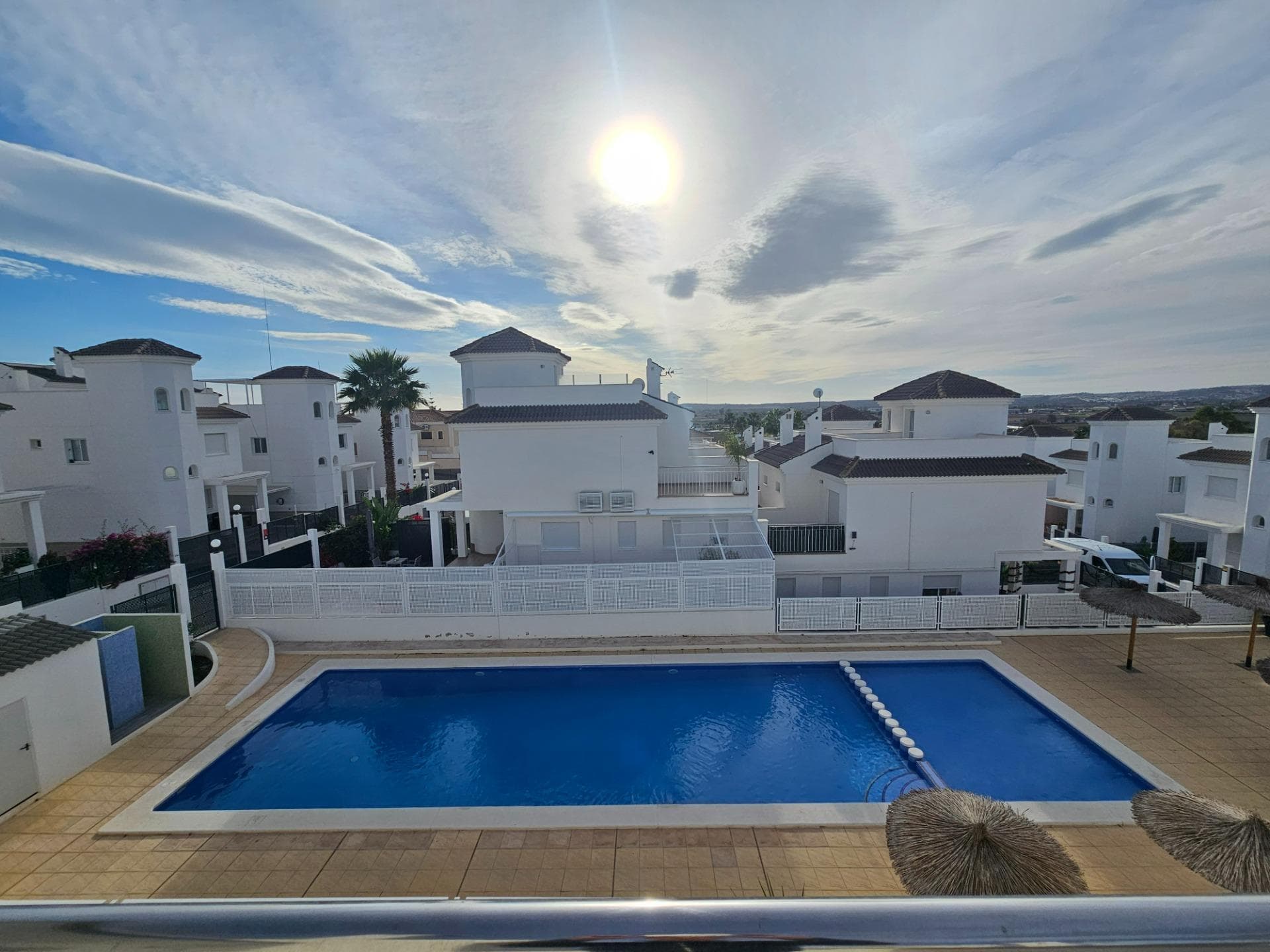 Welcome to your dream home in San Fulgencio, Alicante! This enchanting semi detached villa offers the perfect blend of comfort and luxury. With 3 bedrooms and 3 bathrooms, this bright and inviting residence is ideal for families or those who cherish spacious living. The independent kitchen is fully equipped, offers plenty of storage and has access to a little back patio. Each room comprises of hot and cold air conditioning, ensuring a pleasant atmosphere all year round. The highlight of this property is its stunning outdoor areas that invite relaxation and entertainment amidst magnificent panoramic views. A low maintenance garden area with artifical grass, terrace and lovely palmtrees and fruitplants are perfect so sip your morning coffee. The master bedroom on the first floor gives access to a large south east facing terrace with views at the communal pool and the mountains in the distance. The solarium offers 25M² for hosting an evening gathering under the stars or all day sunbathing. Further we have 2 en suite bathrooms and 1 family bathroom. Under the stairs we can find a confortable storage room. Located just 5km from pristine beaches, you can enjoy sun-soaked days by the sea whenever you desire. Plus, being close to local amenities means everything you need is within easy reach. Meticulously maintained and in good condition, this home promises a worry-free move-in experience. Don’t miss this opportunity to own a piece of paradise—schedule your viewing today and step into a brighter lifestyle!