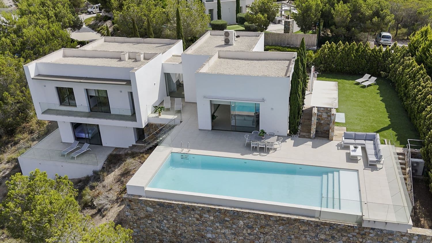 A luxury villa first line to the Las Colinas golf course in Orihuela Costa, this property boasts a stunning infinity pool with views of the course, endless terraces, a cosy back garden, parking for two cars and a beautiful, bright living, dining and kitchen area.   There are a total of four bedrooms and three bathrooms as well as a guest toilet split across two levels with the main living level housing three bedrooms, two bathrooms and the guest toilet and a lower groundfloor hosting a suite with walk in wardrobe, ensuite bathroom and a private terrace that has stairs both up to the pool terrace as well as to the parking.   The villa is characterised by a feeling of space, privacy and tranquility. It is situated on the 'golf island' on Las Colinas which is an exclusive villa area surrounded by the course. Las Colinas is a secure gated community with restricted access and 24 hour security patrols. It is also an area known for its natural beauty and a perfect place if you want to live healthily with sports facilities, numerous restaurants, a nature trail and naturally, the golf course, which is multi award-winning.