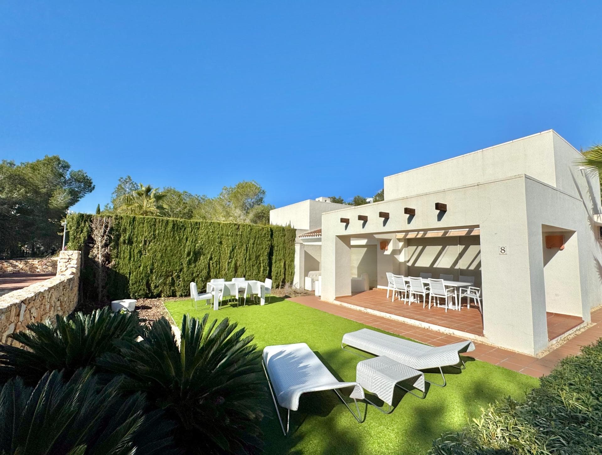 Welcome to Villa Encina, an architectural gem located in the heart of the prestigious Las Colinas complex, where exclusivity, light, and nature come together to offer an unparalleled Mediterranean lifestyle. With 108 m² of built space, fully furnished, and thoughtfully designed, this villa exudes elegance and comfort in every corner. Its spacious bedrooms and bright living areas, south-facing, create a warm and inviting atmosphere, perfect for daily life or entertaining guests. The true charm of Villa Encina lies in its 70 m² covered terrace, a seamless extension of the interior where you can enjoy sunny breakfasts, outdoor dinners, or peaceful moments surrounded by lush greenery. The 372.24 m² plot provides a private garden and a designated parking area, ensuring complete privacy and convenience. Surrounded by top-tier golf courses, nature trails, and high-quality amenities, this villa is more than just a home: it is a Mediterranean sanctuary where every detail has been designed to blend style, light, and well-being. Villa Encina offers the opportunity to experience the authentic Las Colinas lifestyle—a move-in ready home, inviting you to enjoy life, serenity, and sophistication in an incomparable setting.