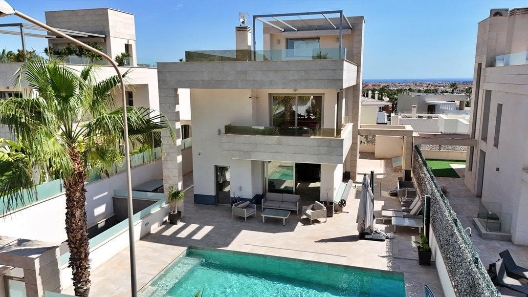 Discover this exceptional five-bedroom detached villa in the heart of Villamartin, one of the most sought-after residential areas on the Orihuela Costa, Costa Blanca South, Spain. Set across generous living space, this beautifully presented property offers five spacious double bedrooms, each with its own en-suite bathroom, plus an additional guest WC — ideal for families, holiday hosting, or rental investment. The villa is sold fully furnished and ready to move into. The ground floor features an inviting open-plan living and dining area that flows seamlessly to the outdoor terrace and pool area, a fully equipped modern kitchen, and convenient guest accommodation. Upstairs, the remaining bedrooms enjoy plenty of natural light, with the top-floor master suite boasting breathtaking panoramic sea views across the Mediterranean coastline. Step outside to your own private heated swimming pool, perfect for year-round enjoyment, surrounded by landscaped gardens and sun terraces designed for relaxation and alfresco dining. The rooftop solarium is a standout feature, offering spectacular 360-degree views over the sea, the prestigious Villamartin Golf Course, and the surrounding countryside. Additional highlights include a private garage with ample storage, making this villa a complete turnkey package. Location is everything, and this villa delivers. Just a short stroll from the famous Villamartin Plaza — home to a vibrant selection of restaurants, cafés, bars, and shops — you are also moments from championship golf courses, beautiful sandy beaches at La Zenia and Cabo Roig, and the renowned La Zenia Boulevard shopping centre. With excellent transport links to Alicante-Elche Airport (approximately 40 minutes) and Murcia International Airport, this property is perfectly positioned for permanent living, a holiday retreat, or a high-yield rental investment on the Costa Blanca. Key features: 5 bedrooms with en-suite bathrooms, guest WC, heated private pool, rooftop solarium with sea and golf views, private garage, fully furnished, close to Villamartin Golf Course and Plaza, near beaches and amenities.