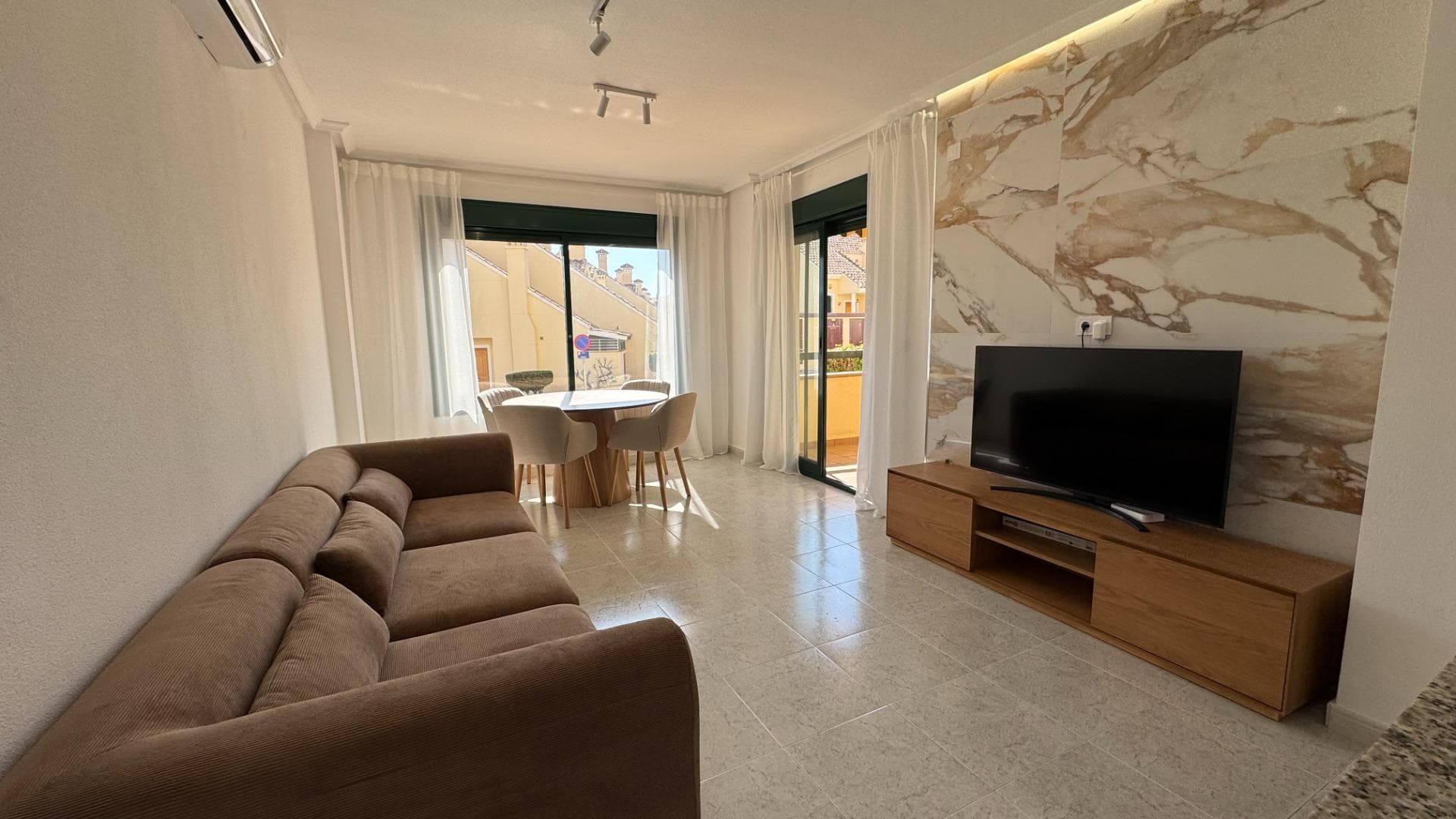 Exclusive fully renovated apartment in a prestigious golf area Welcome to this elegant fully renovated apartment located in the highly desirable area of Lomas de Campoamor, surrounded by some of the finest golf courses on the Costa Blanca. Positioned on an elevated ground floor and facing south, this beautiful property offers privacy, natural light and peaceful open views in a quiet and prestigious environment. The apartment has been completely renovated with high quality materials and modern finishes, creating a stylish and comfortable atmosphere ideal both for permanent living and holiday stays. Its exterior-facing layout with no internal patios allows every room to feel bright, airy and welcoming throughout the day. Inside you will find 2 spacious bedrooms, 1 elegant bathroom with a modern walk-in shower and 1 separate toilet, as well as a beautifully designed living area finished with designer furniture, natural stone details and large-format porcelain flooring. The property comes fully equipped with inverter air conditioning, central gas heating, dual boiler system, Smart TV, washing machine with direct drive technology, alarm system and concealed ambient LED lighting. The residential complex offers a well-maintained communal swimming pool, landscaped green areas and lift access, creating a relaxing Mediterranean lifestyle just moments away from renowned golf courses, restaurants and services. This renovated apartment is located in one of the most demanded golf areas of the Costa Blanca, making it not only a comfortable and stylish home, but also an excellent investment opportunity.