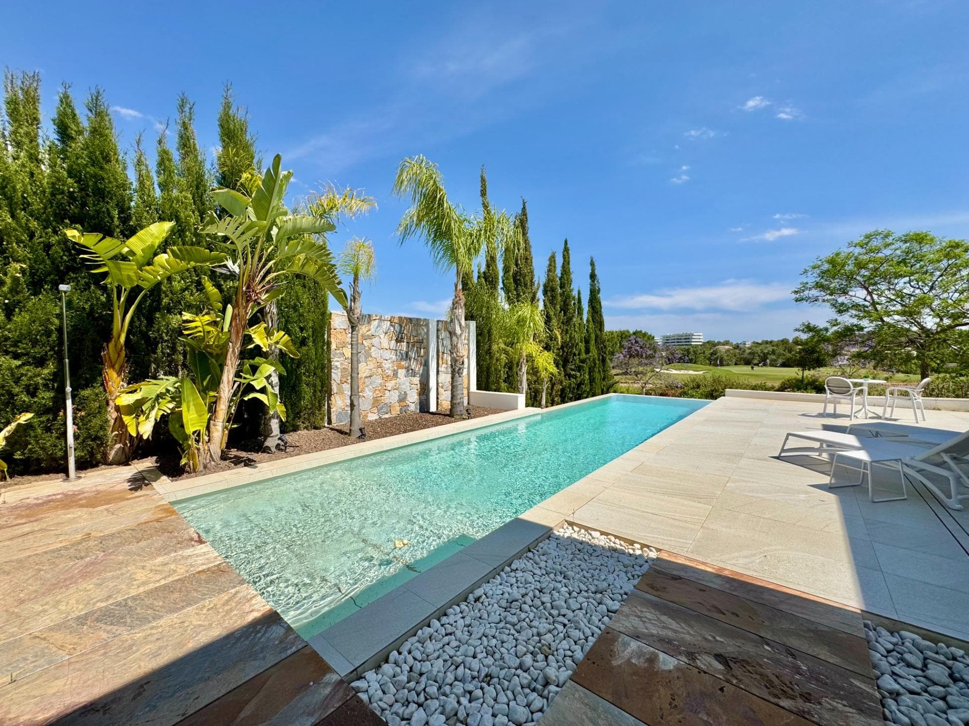 frontline golf villa with panoramic views in las colinas golf & country club  Located in one of the most exclusive communities of Las Colinas, this stunning modern villa enjoys a unique frontline golf position. A property where luxury, privacy and tranquility come together perfectly, surrounded by nature and offering breathtaking open views over the golf course, the green landscape and the sea in the distance. Built on a 732 m² plot, the villa offers 200 m² of built area, designed to maximize natural light and create a seamless connection between indoor and outdoor living. Thanks to its south orientation, you can enjoy sunshine all day long on the spacious terraces and around the private swimming pool. Inside, the villa features an elegant open-plan living area with large windows, a fully equipped designer kitchen, 3 bedrooms and 2 stylish bathrooms. Several rooms enjoy spectacular views over the golf course and the natural surroundings of Las Colinas. The property is finished with high-quality materials and equipped with all modern comforts including underfloor heating, air conditioning, home automation, electric shutters, LED lighting and a landscaped garden with multiple terraces and private parking. Located in a secure resort with low building density, just minutes away from restaurants, sports facilities and the beaches of Campoamor and La Zenia, this villa offers a unique lifestyle on the Costa Blanca. an exceptional property for those looking for luxury, privacy and one of the best locations within las colinas golf & country club