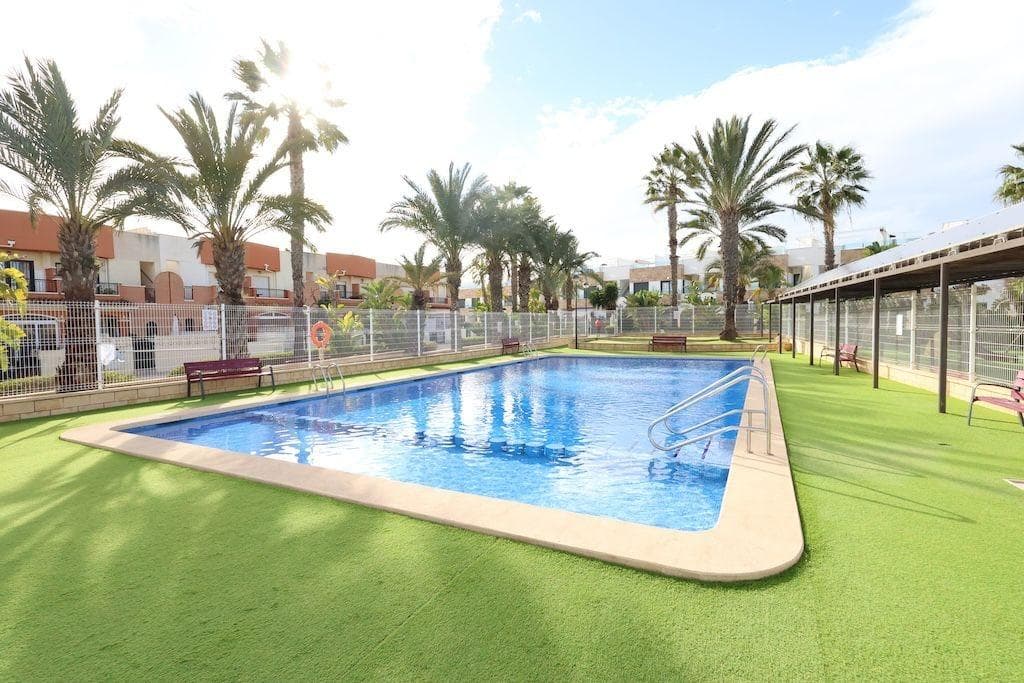 Playa Flamenca, Residencial El Manantial semi-detached house with south facing two floors plus basement intended for garage of 101 m2 and 97 m2 of garage, the house has 3 bedrooms (1 of them on the ground floor) and 3 bathrooms, living room, kitchen open to the living room with back patio, large front garden in front of the communal area and a large solarium with views of the communal areas and the 2 communal swimming pools and children's play area.