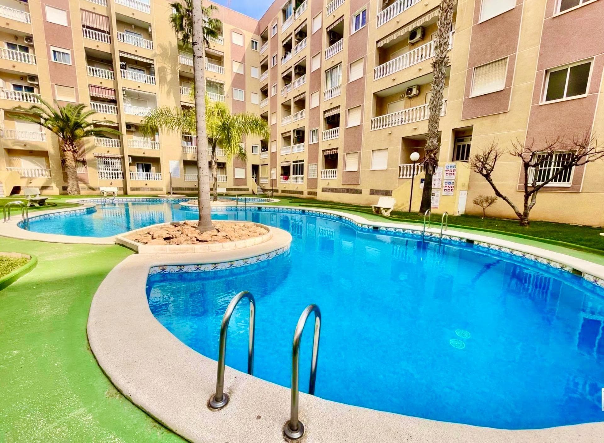 BARGAIN!!! BIG PRICE DROP!! This beautiful 2-bedroom apartment with a communal pool is for sale in the Parque de las Naciones area, located in one of the best residential complexes in the area, highly sought after for its green spaces and large gardens surrounding the pool. The property is ready to move into, fully furnished, and consists of 2 bedrooms, an open-plan kitchen with living–dining room, a spacious bathroom with ventilation, and a cozy terrace. It is perfect both as an investment and as a first or second home. As for its location, it is just a few minutes’ walk from the city center and a 10-minute walk from the promenade. Call us and come visit it!!!