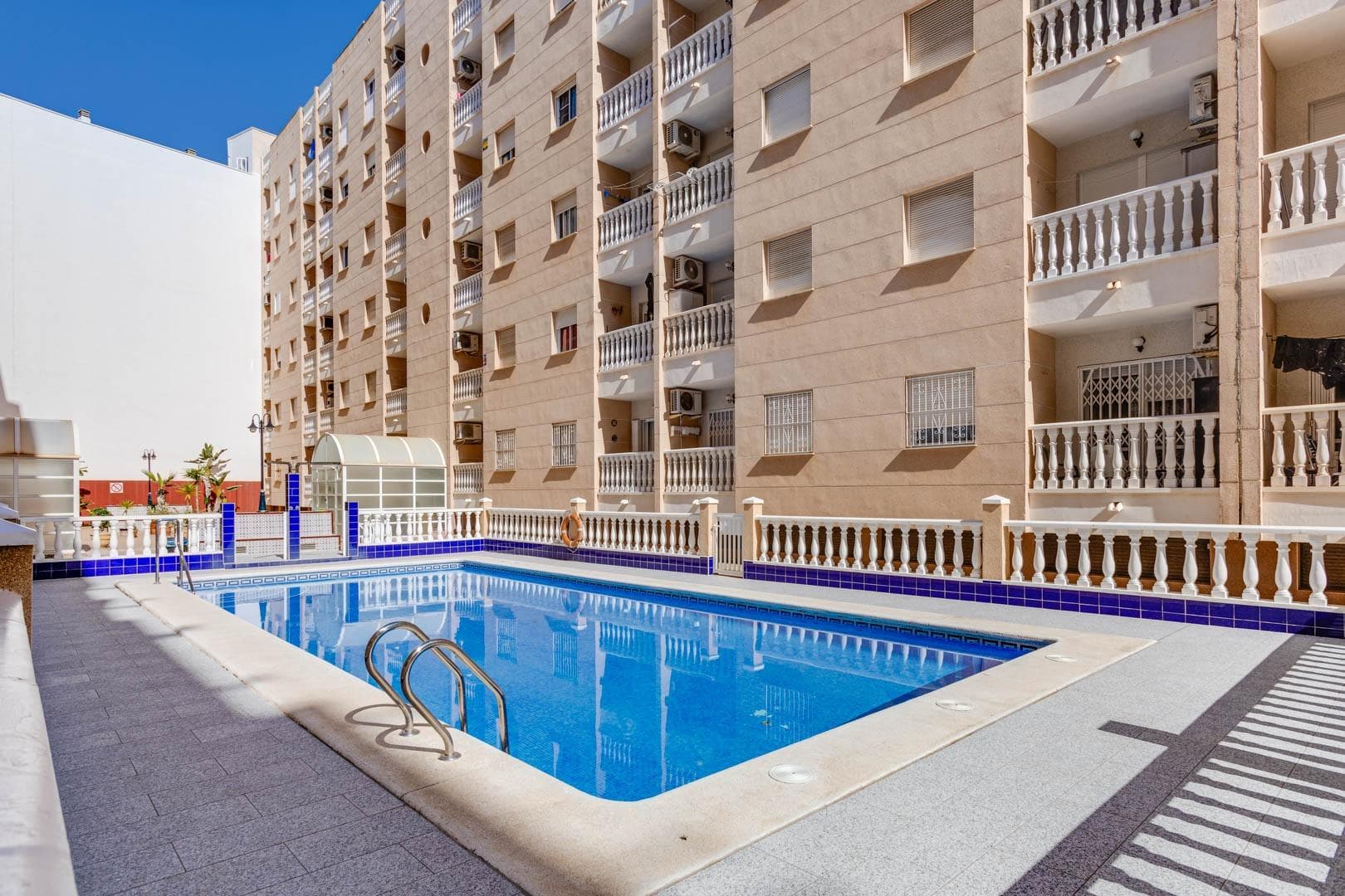 Dreaming of a comfortable home close to the sea? This bright and well-designed apartment in central Torrevieja offers everything you need for both permanent living and holiday enjoyment. The property features two spacious bedrooms, a modern bathroom, and a bright living room with access to a lovely balcony – perfect for your morning coffee or relaxing evenings. The apartment is equipped with air conditioning, ensuring a pleasant indoor climate all year round. Located in an attractive area, the building offers a communal pool where you can enjoy the sun and take a refreshing dip. With only 600 meters to the beach, the Mediterranean is always within easy reach, while restaurants, shops, and all services are just around the corner. An ideal home for those seeking a central location, proximity to the sea, and comfortable living in the sun. Legal costs and VAT are not included in the price.