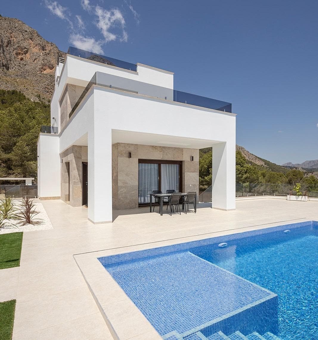 Stunning New Build Villas in Polop with Sea ViewsModern Villas with Spacious Plots and Private PoolsDiscover these exclusive new-build villas in Polop, located on large plots starting from 351 m². These homes offer a perfect blend of modern design, comfort, and breathtaking sea views. Each villa features a 7x3m private swimming pool with a sunbathing area, a large terrace and porch, and private parking space, making it the ideal retreat for those seeking both tranquility and luxury.Two Villa Models to Suit Your LifestyleBuyers can choose between two different villa designs, available in one or two-story layouts. For those looking to maximize their outdoor space, an optional private solarium is available, offering panoramic sea views—the perfect spot to soak up the Mediterranean sunshine that graces the region most of the year.High-Quality Finishes and Energy EfficiencyThese villas are built with top-quality materials and modern finishes, ensuring comfort and energy efficiency:Motorized blinds in the living room, kitchen, and bedrooms.Underfloor heating in all bathrooms.Pre-installed ducted air conditioning for year-round comfort.Mediterranean-style landscaped garden, designed for low maintenance.Reinforced security entrance door for added peace of mind.Aerothermal system for hot water supply.Three photovoltaic solar panels, contributing to an A-rated energy efficiency certificate.Prime Location in Polop, Close to the CoastPolop is a charming Mediterranean town in the Marina Baja region, northeast of Alicante. Known for its rich history, vibrant gastronomy, and stunning natural surroundings, the town offers a peaceful lifestyle while remaining close to the coast.Nearby Points of Interest:Polop to Benidorm – 15 minutes by car (famous for beaches, shopping, and nightlife).Polop to Altea – 15 minutes by car (renowned for its historic old town and marina).Polop to Alicante City – 30 minutes.Alicante International Airport – 40 minutes.La Nucía – 5 minutes (famous for world-class sports facilities).Nearest beach – 8 km.The Perfect Combination of Nature and ConvenienceWith easy access to the AP-7 motorway, residents enjoy quick connections to all major towns along the Costa Blanca. Polop also offers scenic hiking trails, making it an excellent choice for nature lovers and outdoor enthusiasts.Secure your dream home today! Contact us for more information or to schedule a visit.