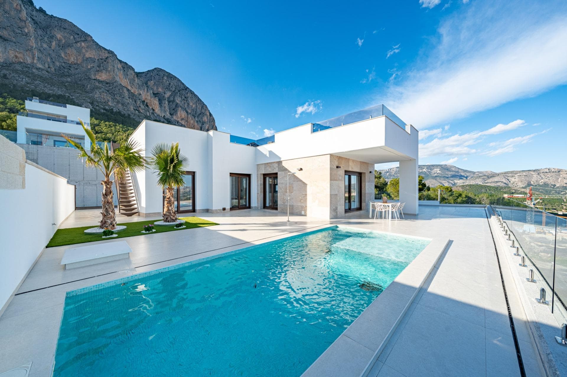 Stunning New Build Villas in Polop with Sea ViewsModern Villas with Spacious Plots and Private PoolsDiscover these exclusive new-build villas in Polop, located on large plots starting from 351 m². These homes offer a perfect blend of modern design, comfort, and breathtaking sea views. Each villa features a 7x3m private swimming pool with a sunbathing area, a large terrace and porch, and private parking space, making it the ideal retreat for those seeking both tranquility and luxury.Two Villa Models to Suit Your LifestyleBuyers can choose between two different villa designs, available in one or two-story layouts. For those looking to maximize their outdoor space, an optional private solarium is available, offering panoramic sea views—the perfect spot to soak up the Mediterranean sunshine that graces the region most of the year.High-Quality Finishes and Energy EfficiencyThese villas are built with top-quality materials and modern finishes, ensuring comfort and energy efficiency:Motorized blinds in the living room, kitchen, and bedrooms.Underfloor heating in all bathrooms.Pre-installed ducted air conditioning for year-round comfort.Mediterranean-style landscaped garden, designed for low maintenance.Reinforced security entrance door for added peace of mind.Aerothermal system for hot water supply.Three photovoltaic solar panels, contributing to an A-rated energy efficiency certificate.Prime Location in Polop, Close to the CoastPolop is a charming Mediterranean town in the Marina Baja region, northeast of Alicante. Known for its rich history, vibrant gastronomy, and stunning natural surroundings, the town offers a peaceful lifestyle while remaining close to the coast.Nearby Points of Interest:Polop to Benidorm – 15 minutes by car (famous for beaches, shopping, and nightlife).Polop to Altea – 15 minutes by car (renowned for its historic old town and marina).Polop to Alicante City – 30 minutes.Alicante International Airport – 40 minutes.La Nucía – 5 minutes (famous for world-class sports facilities).Nearest beach – 8 km.The Perfect Combination of Nature and ConvenienceWith easy access to the AP-7 motorway, residents enjoy quick connections to all major towns along the Costa Blanca. Polop also offers scenic hiking trails, making it an excellent choice for nature lovers and outdoor enthusiasts.Secure your dream home today! Contact us for more information or to schedule a visit.