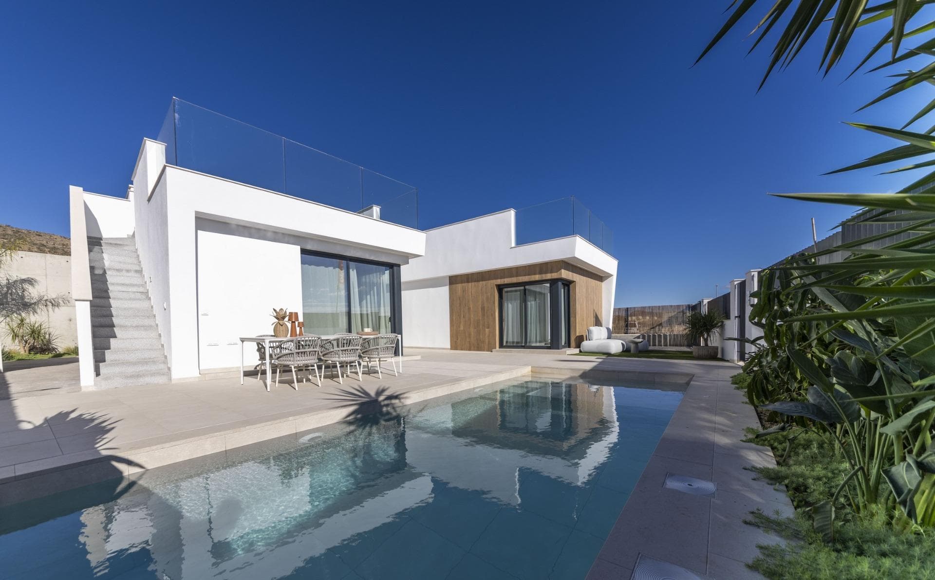 New Build Villas in Altaona Golf Resort Murcia with Private Pool and Mountain ViewsContemporary Villas in Altaona Golf Resort MurciaDiscover an exclusive new development of modern villas located in Altaona Golf Resort, one of the most attractive residential areas in Murcia. Surrounded by natural landscapes and mountains, this secure golf resort offers a peaceful environment while being just a short drive from the city of Murcia and the Mediterranean coast.These new build villas are designed to provide comfort, privacy and a relaxed Mediterranean lifestyle. The development offers a selection of villas on one level with optional solarium or two level layouts, all featuring three bedrooms and two bathrooms, including a master bedroom with en suite bathroom.Spacious Design with Private Gardens and PoolEach villa is built on a private plot starting from 300 m2, offering ample outdoor space to enjoy the sunshine all year round. The properties include a private swimming pool, landscaped garden areas and on plot parking.The interior layout is designed to maximize natural light and create a seamless connection between indoor and outdoor living. Open plan living and dining areas connect directly to the terrace and pool, creating the perfect setting for relaxing or entertaining family and friends.Quality Finishes and Modern FeaturesThese villas are built using high quality materials and modern construction techniques to ensure comfort and energy efficiency. Features include a reinforced security entrance door, fully fitted kitchen with appliances, underfloor heating in bathrooms and interior LED lighting package.Additional specifications include pre installation for ducted air conditioning and hot water production via an energy efficient aerothermal system, providing both sustainability and cost savings.Prime Location Close to Golf, City and CoastAltaona Golf Resort is known for its 18 hole golf course, peaceful surroundings and excellent security, making it ideal for both permanent living and holiday homes. The resort offers a unique combination of nature, sport and proximity to key destinations.Murcia city center is located just 15 km away, offering a wide range of shops, restaurants, cultural attractions and services. The beaches of the Mar Menor and the Mediterranean coast are approximately 20 km away, perfect for enjoying sunny days by the sea.Other key distances include Murcia Corvera Airport 15 km, Cartagena city 35 km and several golf courses within a short drive, making this an ideal location for golf lovers and international buyers.Ideal Investment and Mediterranean Lifestyle OpportunityThese new build villas in Altaona Golf Resort offer an excellent opportunity to enjoy a high quality lifestyle in a natural and secure environment, with easy access to both the city and the coast.Contact us today for more information or to arrange a viewing and discover your new home in Murcia.
