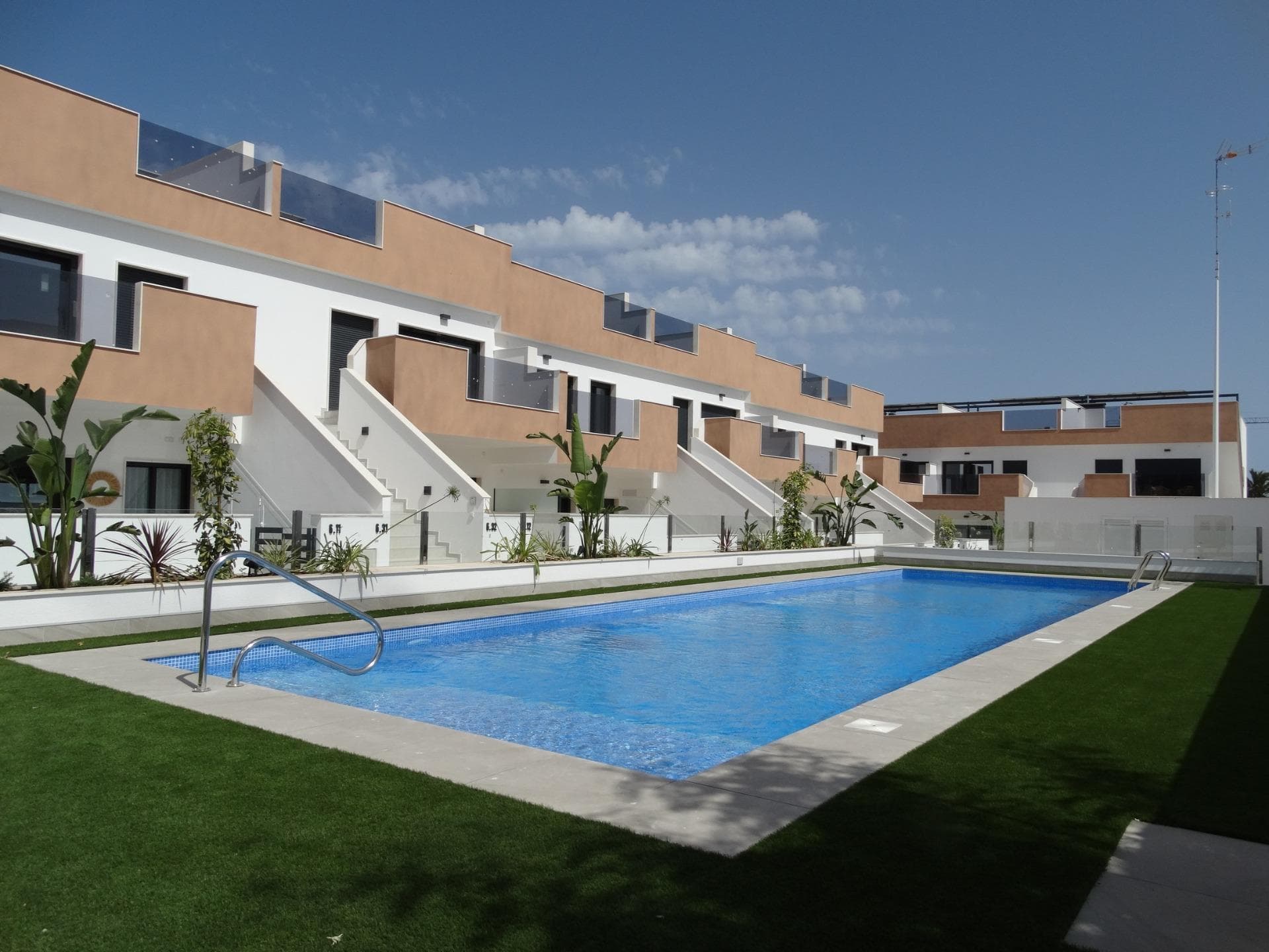 Modern New Build Bungalows for Sale in Pilar de la HoradadaMediterranean Living on the Costa Blanca SouthDiscover this exclusive new build residential complex of modern bungalows located in Pilar de la Horadada, one of the most desirable towns on the Costa Blanca South. Situated on the outskirts of the town center and within walking distance of all daily amenities, this development offers the perfect balance between tranquility, comfort and Mediterranean lifestyle.Pilar de la Horadada is a vibrant coastal town known for its welcoming atmosphere, excellent year round climate and beautiful sandy beaches such as Las Higuericas and Mil Palmeras. The area offers a fantastic selection of restaurants, cafes, sports facilities, cycling routes and golf courses, making it ideal for both permanent living and holiday escapes.Modern Bungalows with Private Garden or SolariumThis contemporary residential complex consists of 40 stylish bungalows with 2 bedrooms and 2 bathrooms, including a master bedroom with ensuite bathroom.Buyers can choose between:Ground floor apartments with private garden and parking within the plot.Top floor apartments with private solarium, storage room and designated parking space on ground floor.Many homes enjoy a south facing orientation, providing excellent natural light throughout the day, cross ventilation and pleasant views over the communal swimming pool and landscaped gardens.The properties have been designed with functional layouts and spacious interiors to maximize comfort and natural light.Quality Features and Comfortable InteriorsEach home includes modern finishes and quality specifications designed for easy Mediterranean living.Features include:Open plan kitchen fully furnished and integrated with the living and dining areaBuilt in wardrobesPrivate terraceAerothermal system for hot waterPre installation for ducted air conditioningPVC exterior carpentry with double glazingModern bathrooms with vanity units and mirrorsExclusive Communal Areas and Outdoor SpacesThe residential complex offers a beautiful communal swimming pool surrounded by landscaped green areas, creating the perfect environment to relax and enjoy the Costa Blanca sunshine all year round.The stunning beaches of Torre de la Horadada and Las Higuericas are located just 3 km away and can easily be reached by bicycle or through the pleasant pedestrian promenade connecting the town with the coast.Excellent Location and Nearby AmenitiesThis development enjoys a privileged location close to all essential services and leisure facilities.Key distances:Las Higuericas Beach: 3 kmMil Palmeras Beach: 4 kmTown center of Pilar de la Horadada: 1 kmLo Romero Golf: 6 kmDos Mares Shopping Center: 11 kmSan Pedro del Pinatar Marina: 12 kmMurcia International Airport: 40 kmAlicante Airport: 65 kmYour New Home on the Costa Blanca AwaitsWhether you are looking for a permanent residence, holiday home or investment property, these modern new build bungalows in Pilar de la Horadada offer an excellent opportunity to enjoy the Mediterranean lifestyle in a prime Costa Blanca location. Contact us today for more information or to arrange your visit.