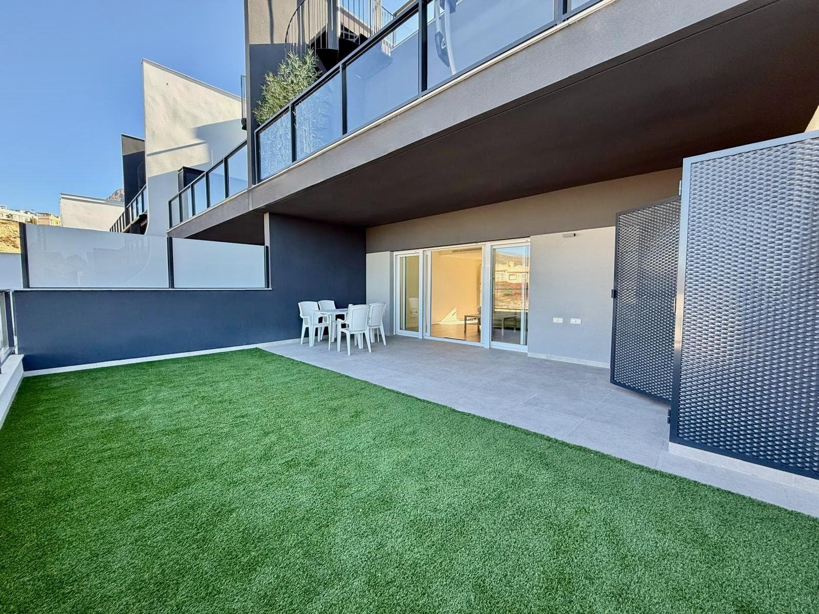 We present a magnificent opportunity to acquire a high-quality home in one of Finestrat's most modern and sought-after residential areas. Located in the prestigious Balcón de Finestrat, this spectacular apartment combines contemporary design, comfort, and breathtaking sea and mountain views, making it an ideal option for year-round living or enjoying a second home on the Costa Blanca. The property boasts 119.51 m² of built area and 108 m² of usable space, efficiently distributed to maximize every inch. It features two spacious double bedrooms with built-in wardrobes and two full bathrooms with underfloor heating, a detail that provides comfort and exclusivity throughout the year. The fully equipped kitchen seamlessly integrates with the living area, creating a modern, functional, and bright ambiance thanks to its large windows. Undoubtedly, one of the highlights of this property is its spectacular 47 m² private terrace. Thanks to its southwest orientation, you can enjoy the sun from midday until sunset while taking in panoramic views encompassing the Mediterranean Sea, the surrounding mountains, and the Benidorm skyline. It's the perfect space to create a chill-out area, host gatherings with family and friends, or simply relax and enjoy the privileged surroundings. The property comes fully furnished and equipped, ready to move in. It also features electric blinds, high-quality finishes, and construction details characteristic of Taylor Wimpey Spain developments, renowned for their quality and design standards. A private parking space is also included, a highly valued feature in this area. The complex offers well-maintained gardens and pleasant communal areas designed for residents' relaxation and enjoyment. Its strategic location combines residential tranquility with excellent access to all amenities. The La Marina Shopping Centre, with its shops, restaurants, supermarkets, and leisure activities, is less than 10 minutes away by car. Supermarkets like Mercadona and local pharmacies are just minutes away, making daily life easier without the need for long journeys. Furthermore, the property is located very close to some of the Costa Blanca's main attractions, such as Poniente Beach, about a 10-minute drive away, several top-level golf courses, and numerous hiking trails that wind through the Puig Campana mountain range. All of this makes this property a sound investment in one of the fastest-growing and most promising areas of the Alicante province.